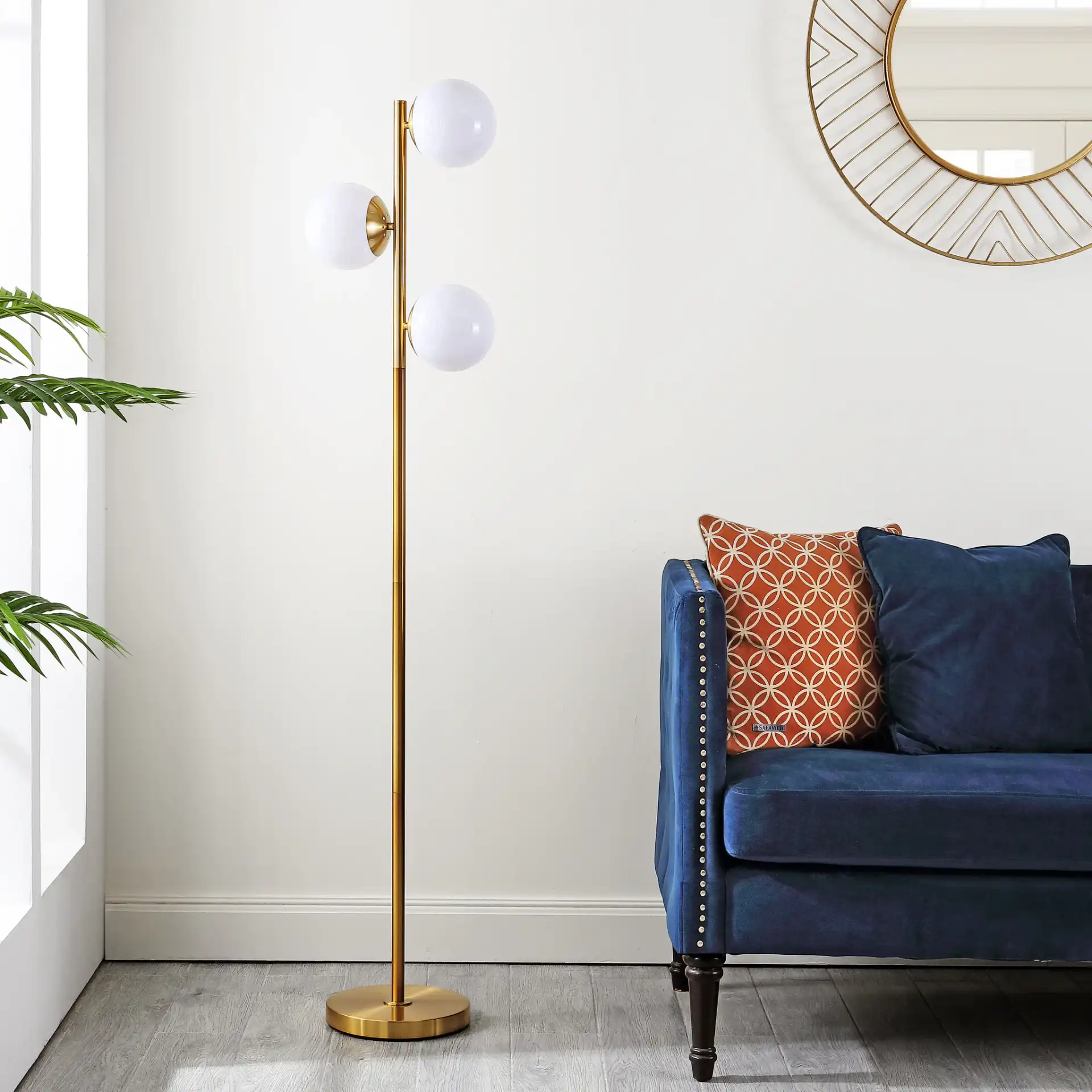 Devlyn Three-Light Floor Lamp in Gold in a styled room