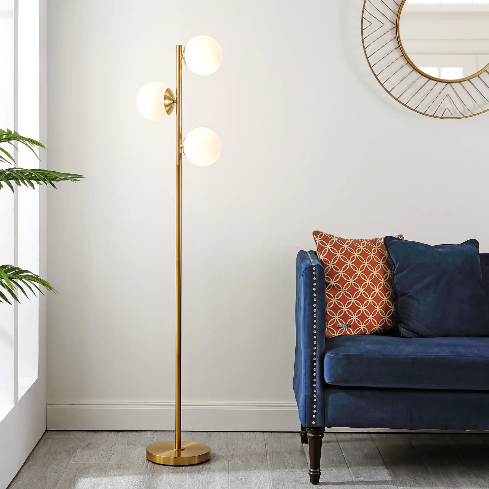 Devlyn Three-Light Floor Lamp in Gold in a styled room