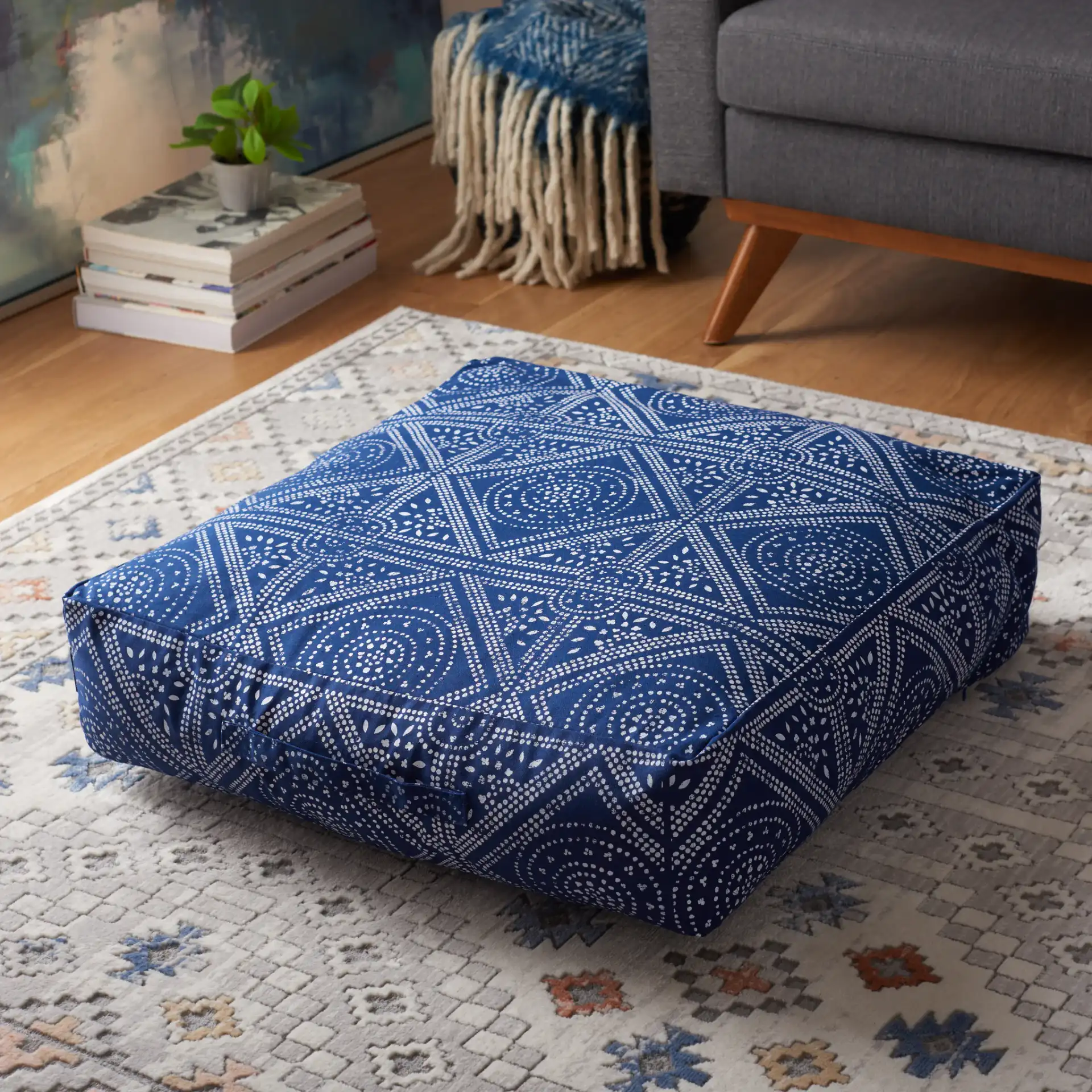 Valenti Square Floor Pillow in Navy Blue / White in a styled room