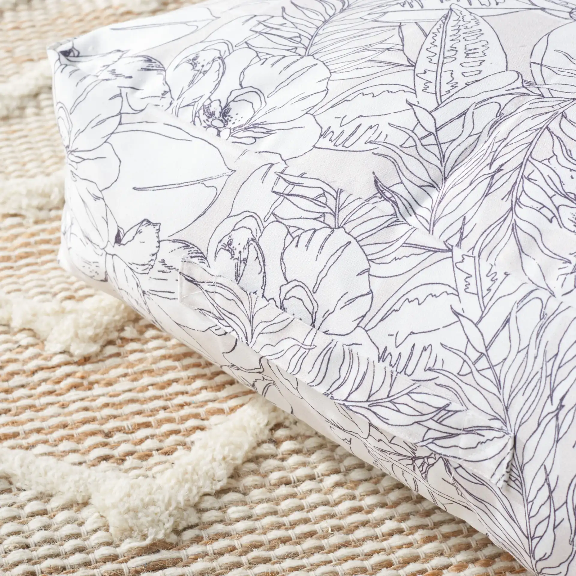 Matlea Floor Pillow in Beige / Gray in a styled room