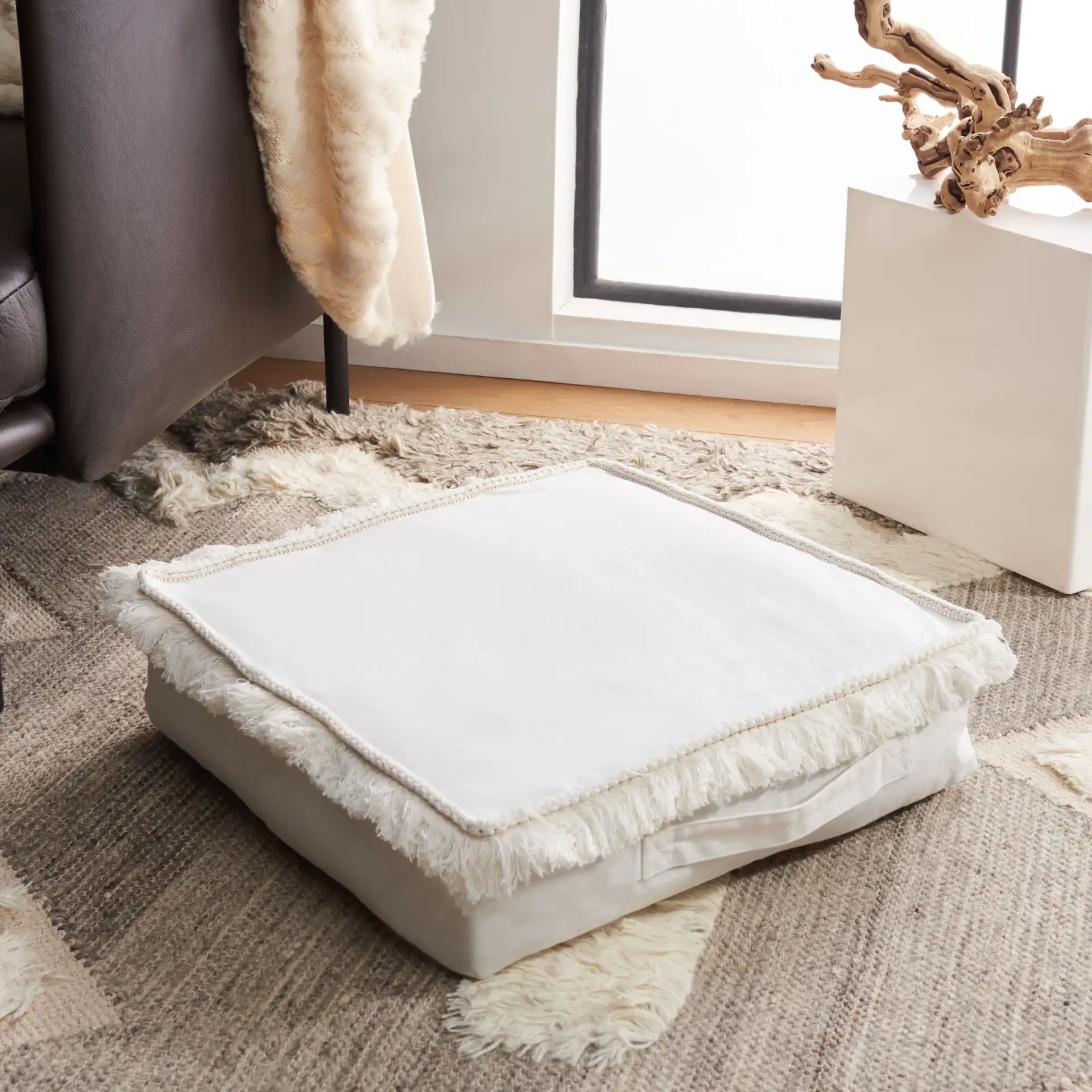 Grema Floor Pillow in Ivory in a styled room