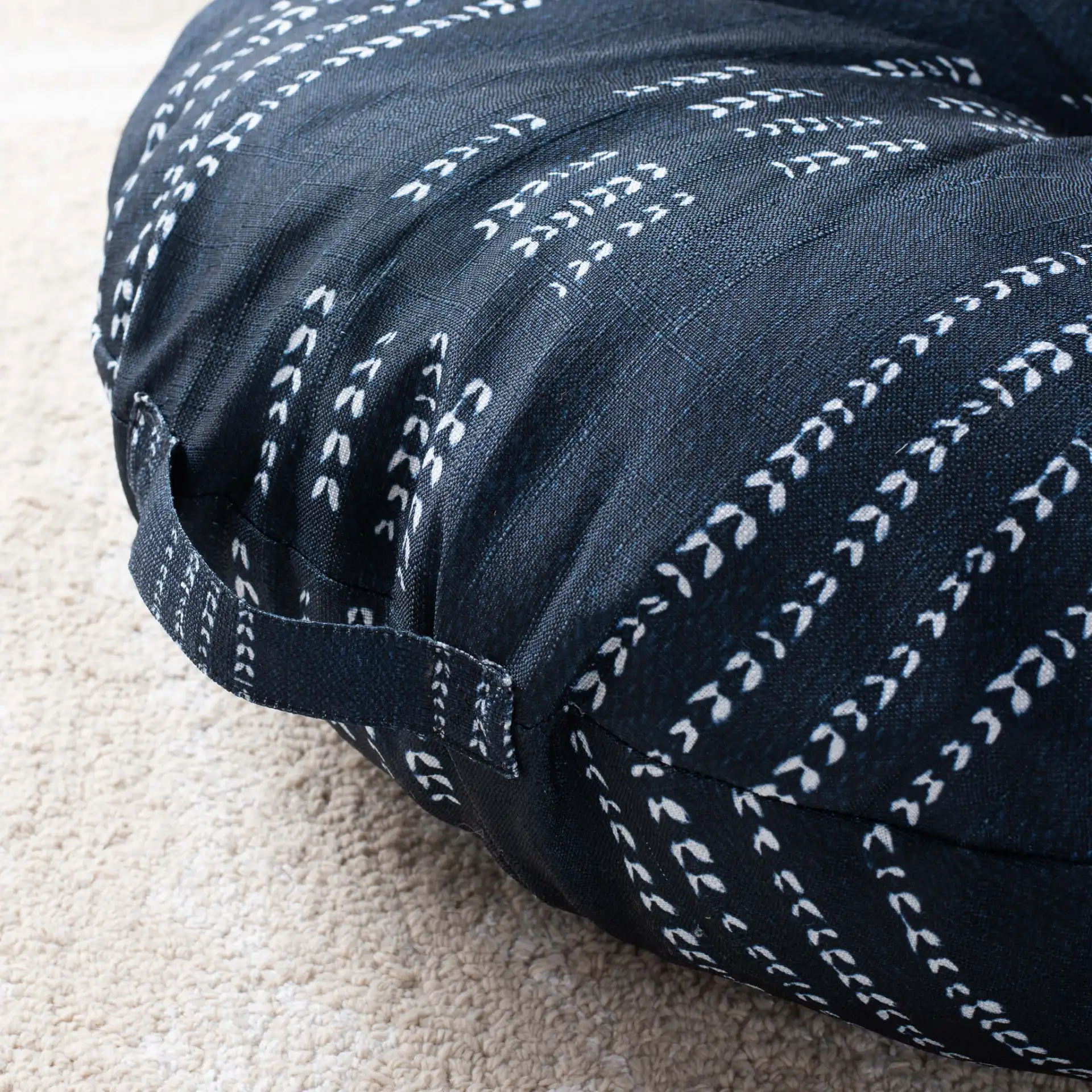 Madelyn Round Floor Pillow in Navy / Ivory in a styled room