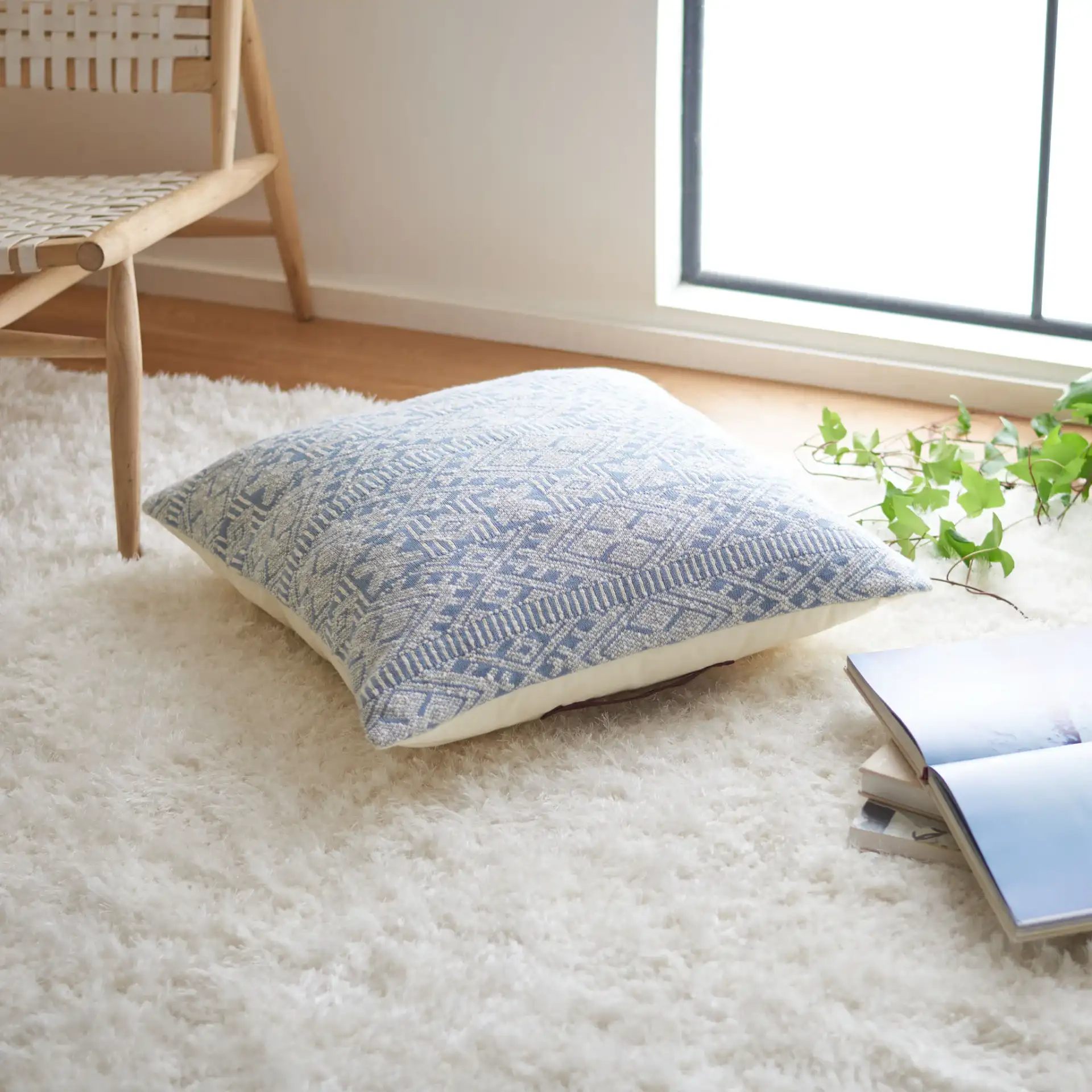 Makela Floor Pillow in Blue / Beige in a styled room