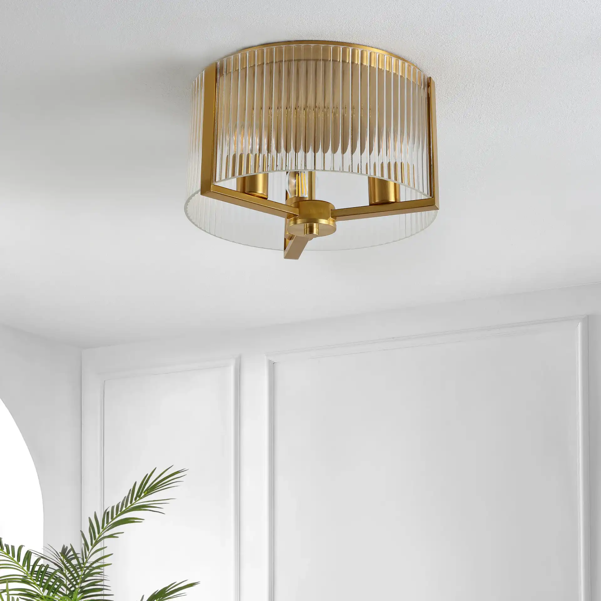 Jetra Three-Light Flush Mount in Brass in a styled room