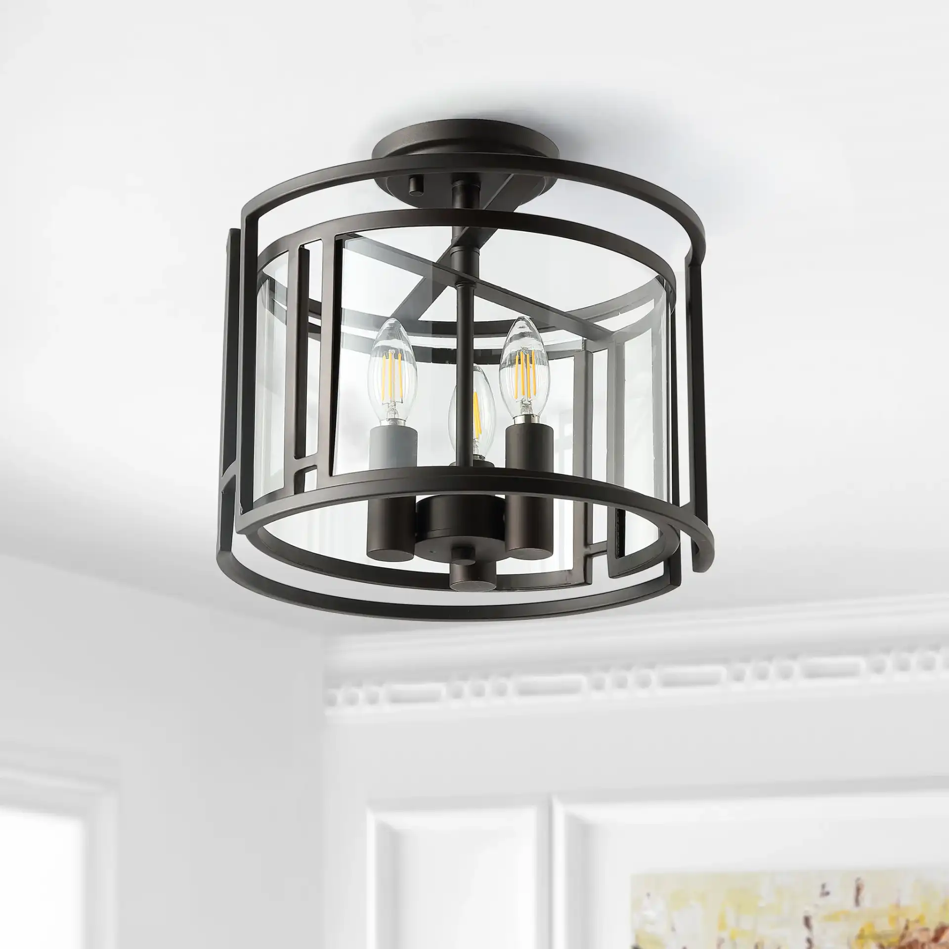 Yarlin Three-Light Flush Mount in Bronze / Clear in a styled room