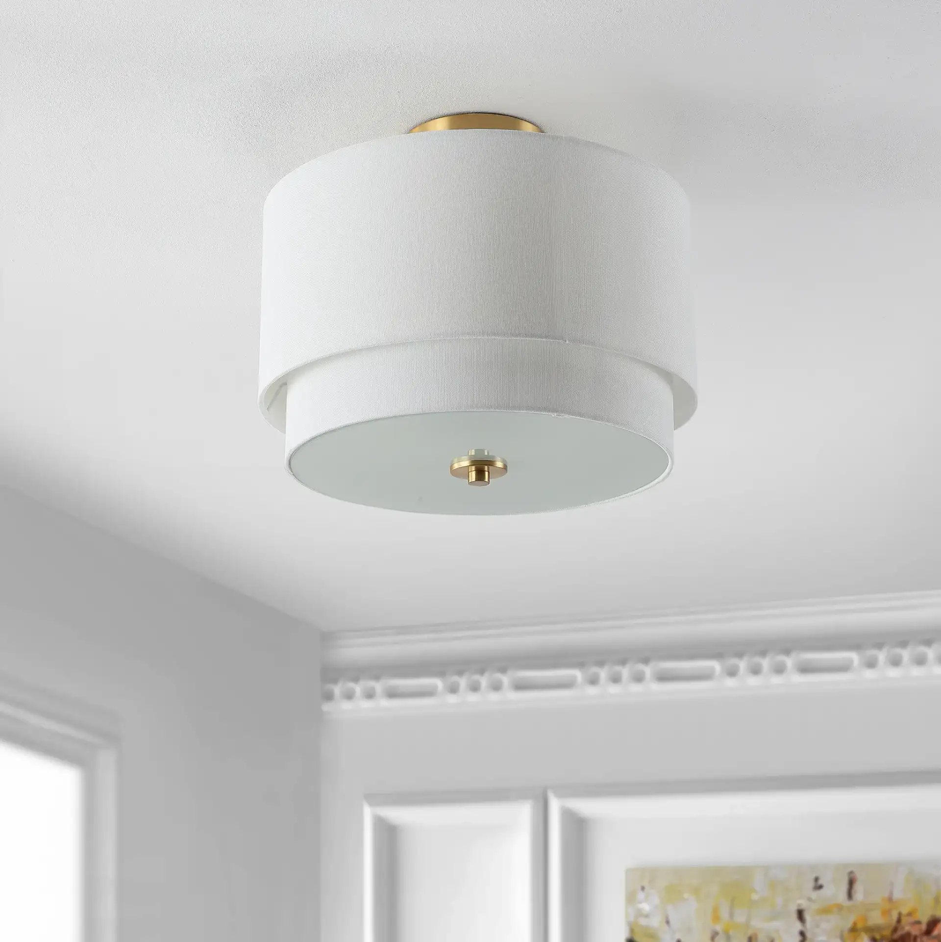 Laconia Three-Light Flush Mount in White / Gold in a styled room