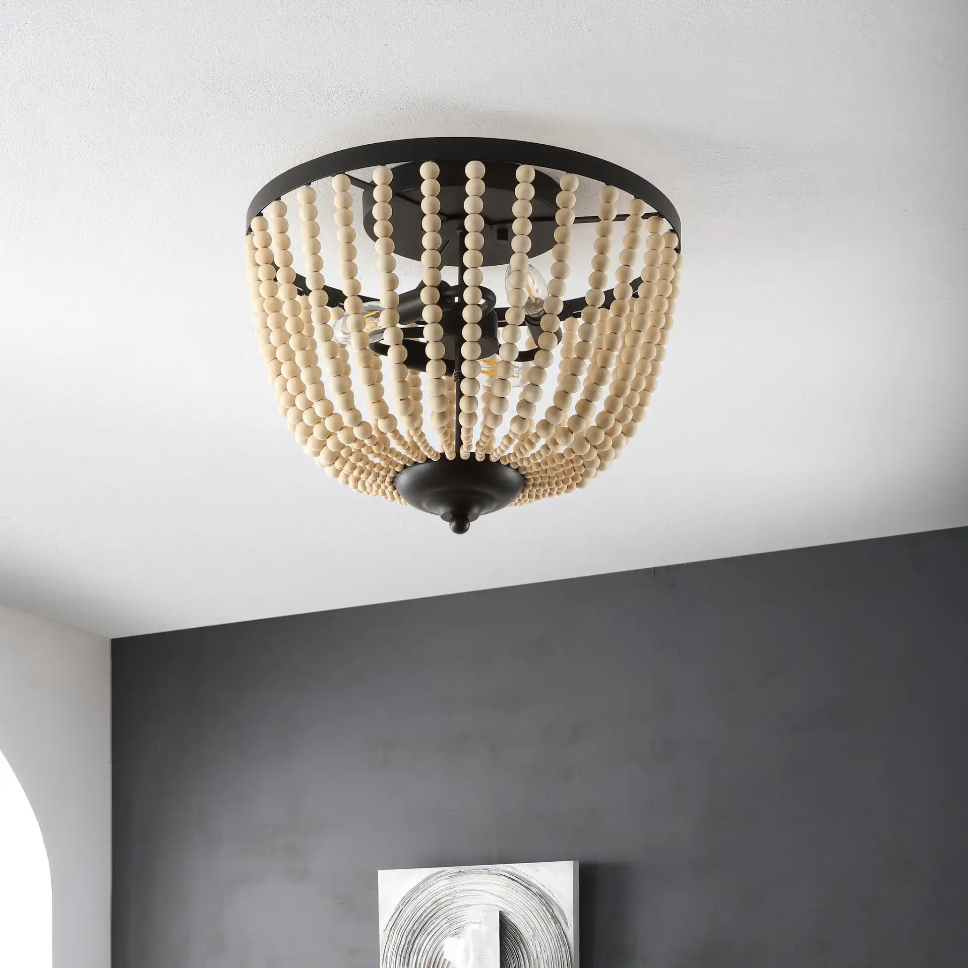 Hamlin Three-Light Flush Mount in Bronze / Natural in a styled room