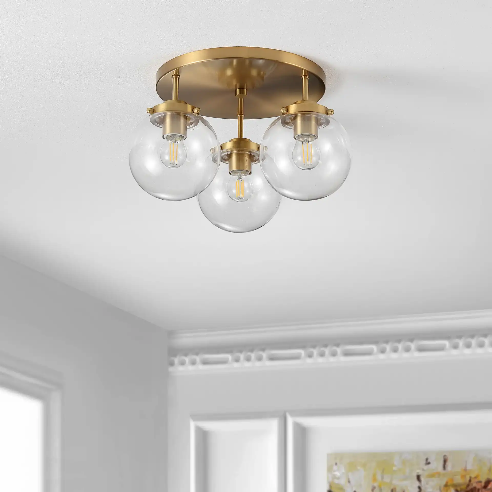 Ginesta Three-Light Flush Mount in Gold / Clear in a styled room