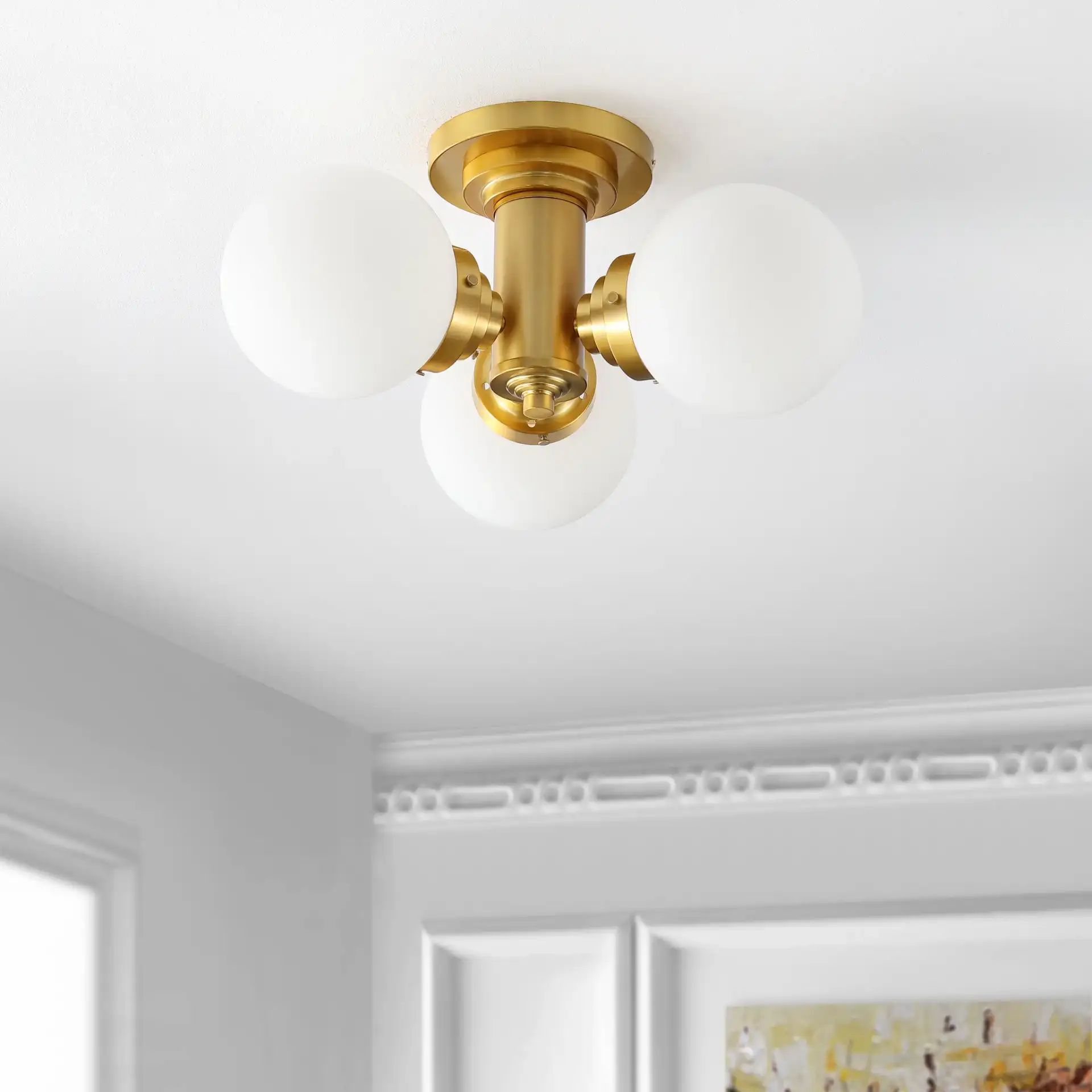 Elenna Three-Light Flush Mount in Gold in a styled room
