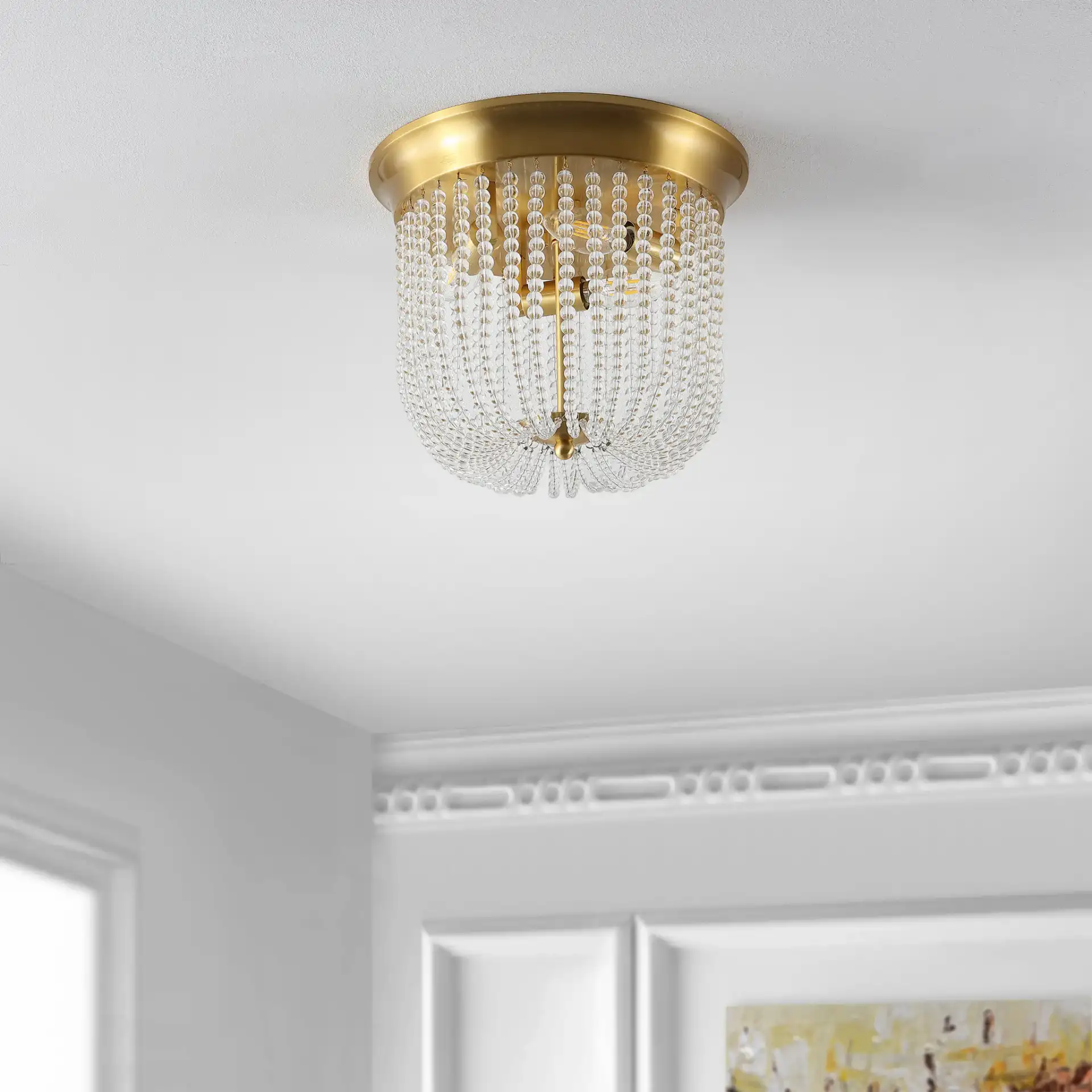 Sarella Three-Light Flush Mount in Gold in a styled room