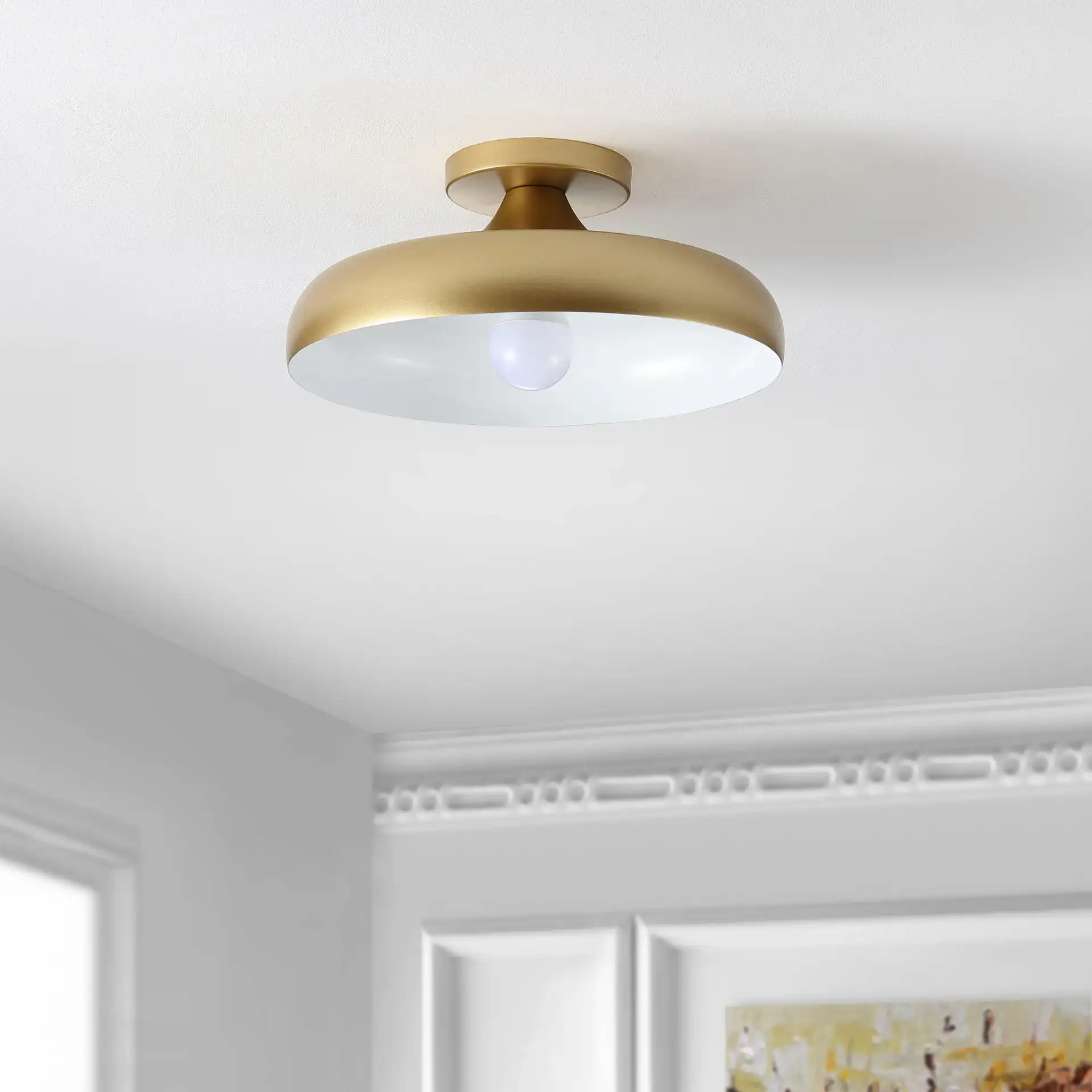 Willet Flush Mount in Gold in a styled room