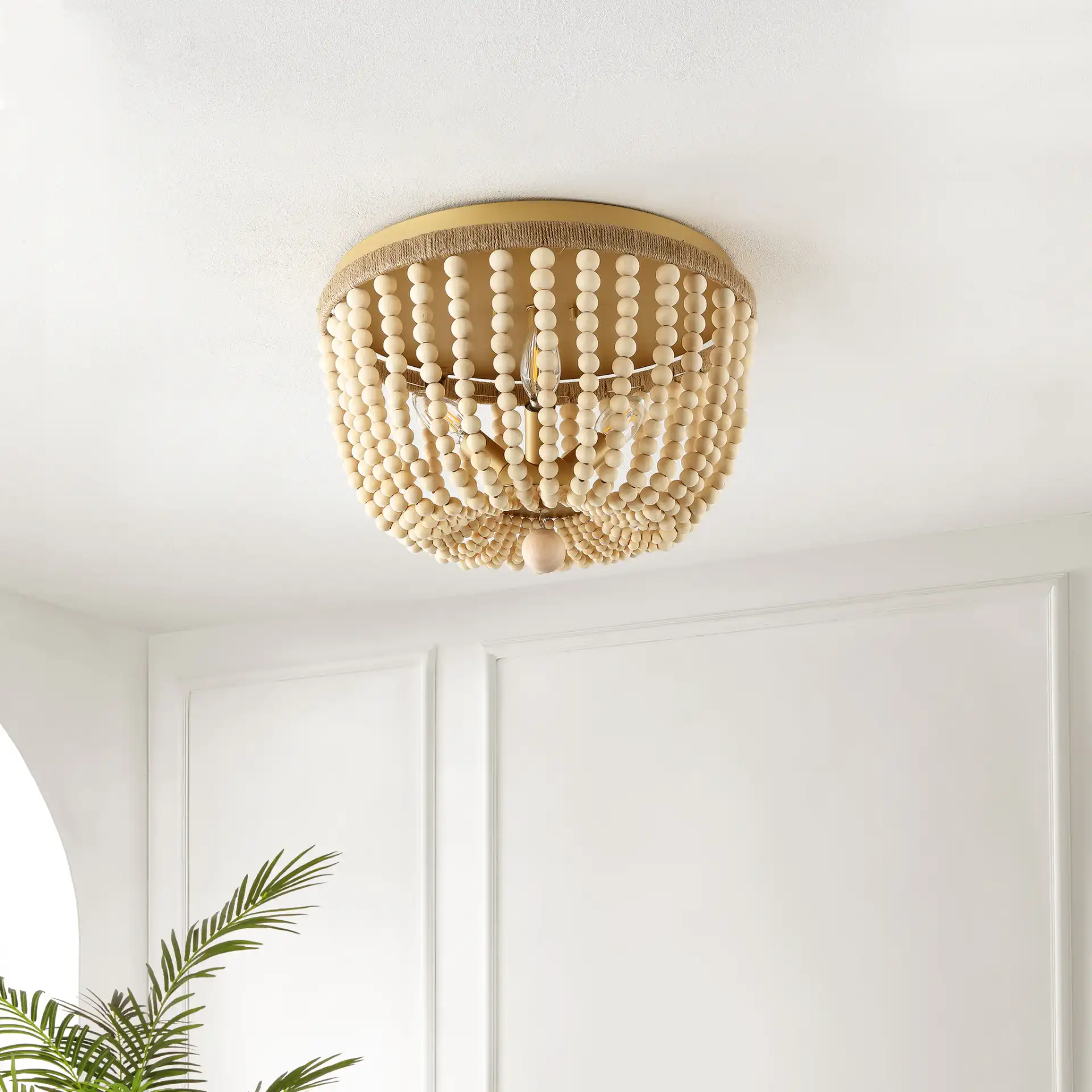 Alodia Three-Light Flush Mount in Brass / Natural in a styled room