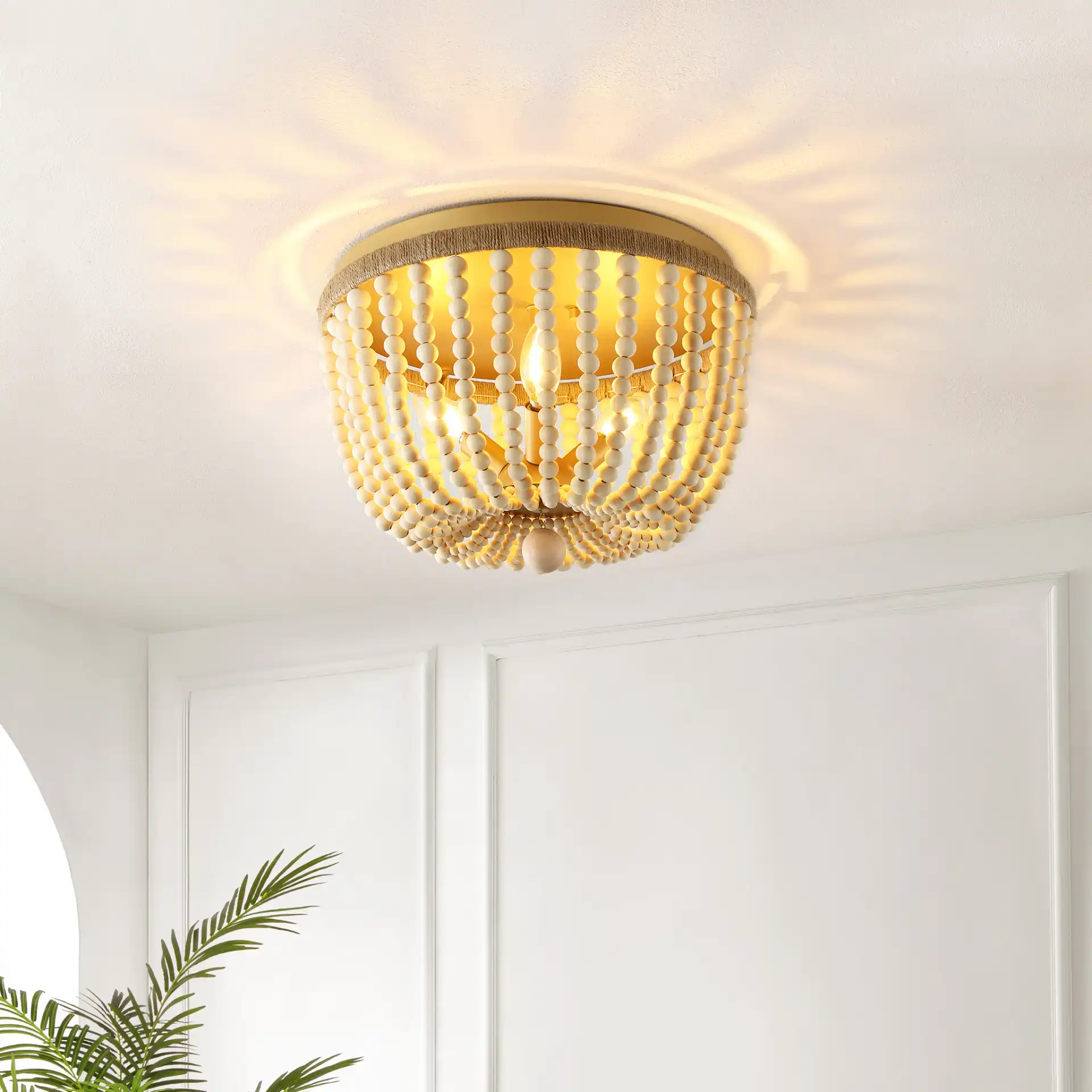 Alodia Three-Light Flush Mount in Brass / Natural in a styled room