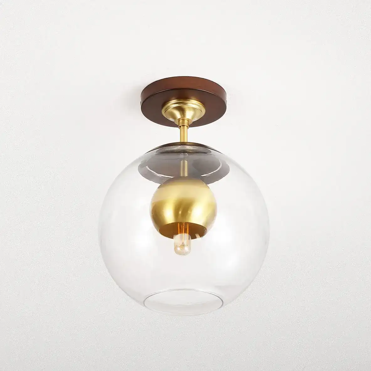 Clyenne Flush Mount in Dark Walnut / Brass in a styled room