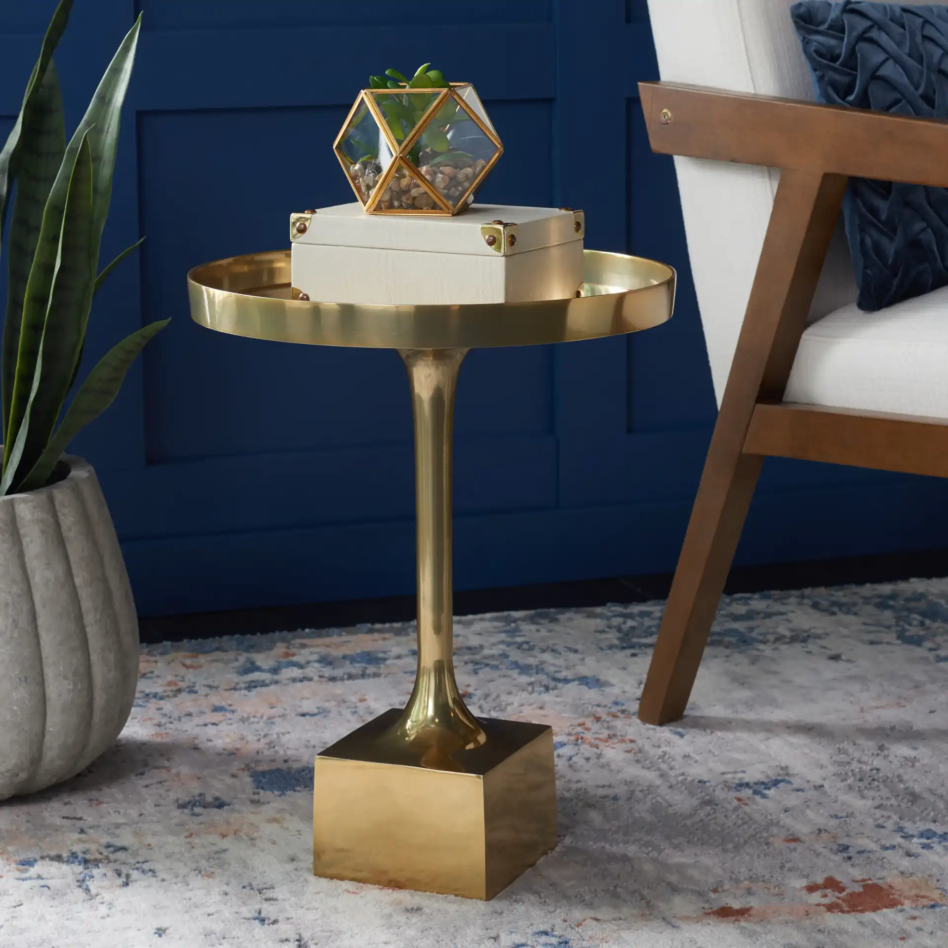Corvus Round Side Table in Antique Brass in a styled room