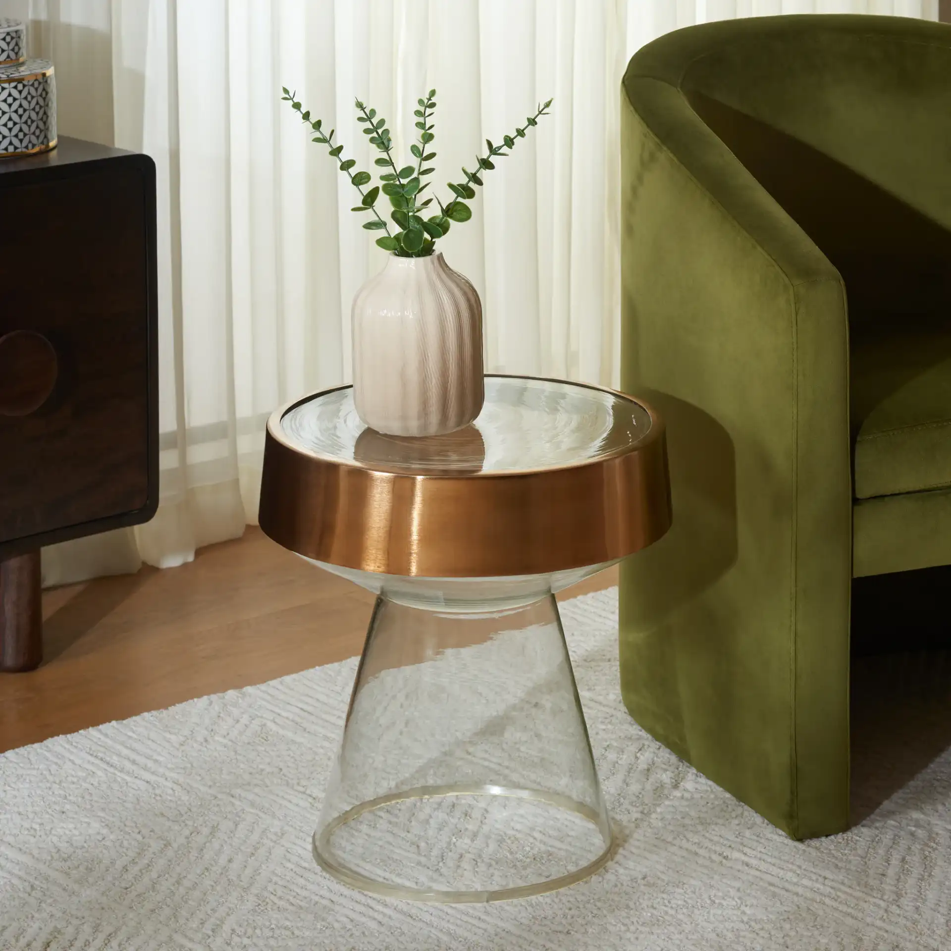 Szabo Round Accent Table in Gold / Clear in a styled room