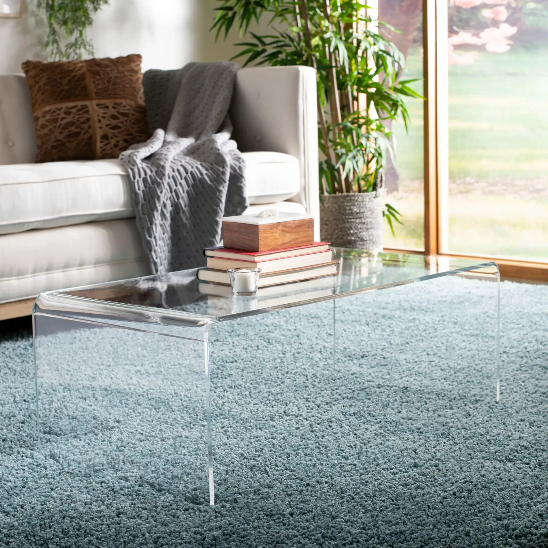 Atka Acrylic Coffee Table in Clear in a styled room