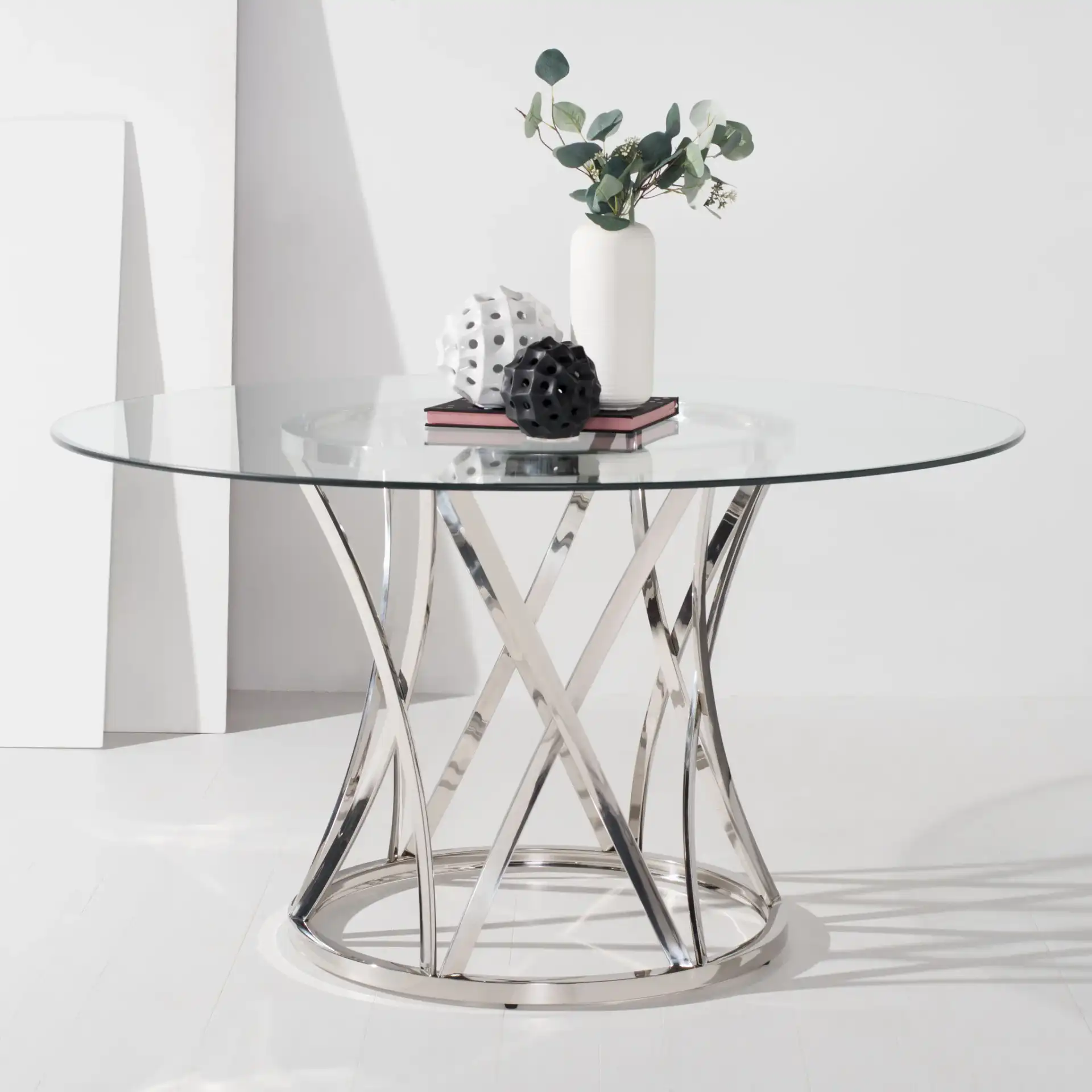 Kyrie 54-Inch Glass Dining Table in Chrome in a styled room