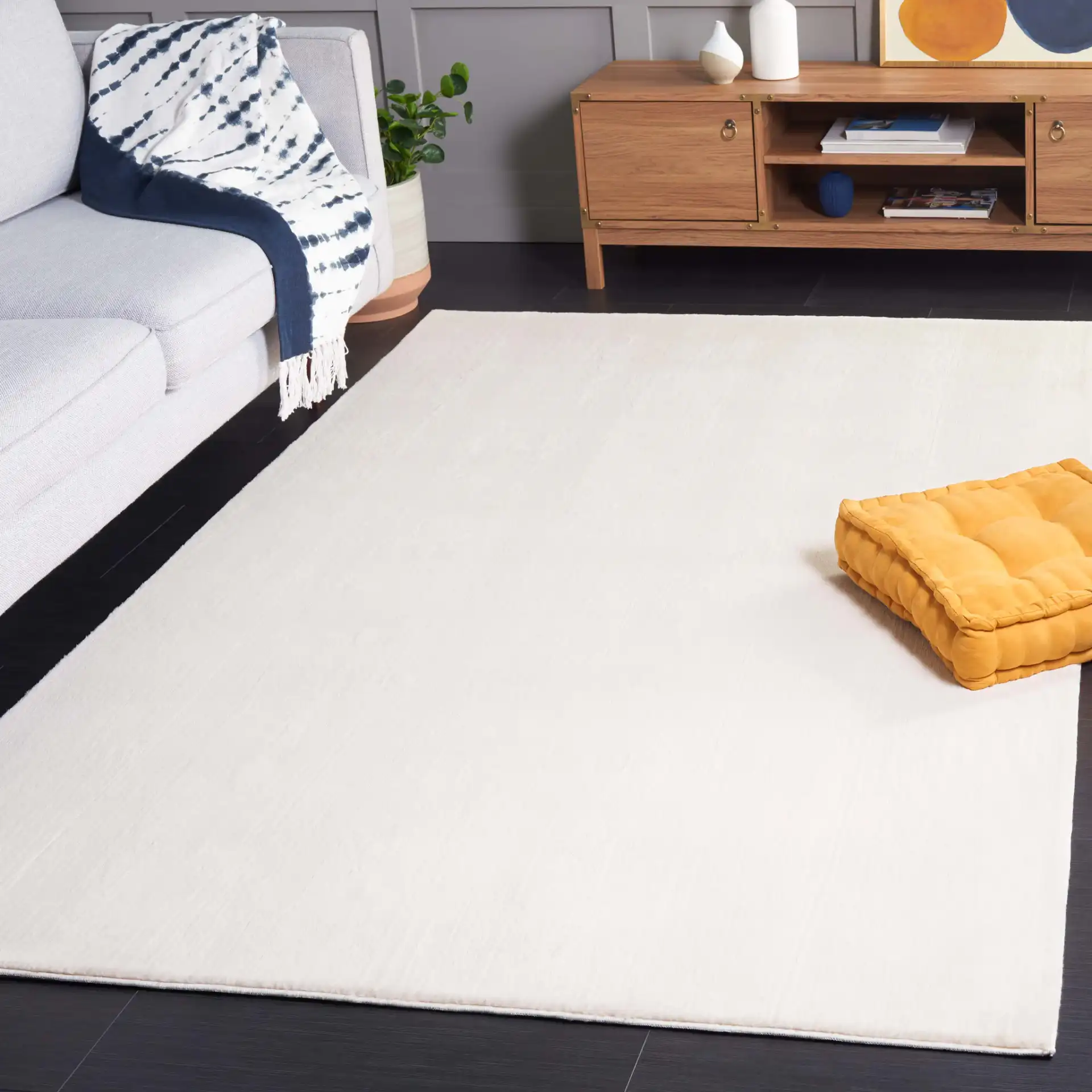 Faux Rabbit Fur Solid Washable Rug in Beige in a styled room