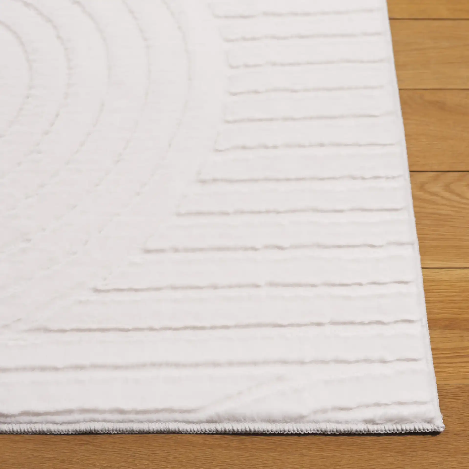 Faux Rabbit Fur Concentric Arches Washable Rug in Ivory in a styled room