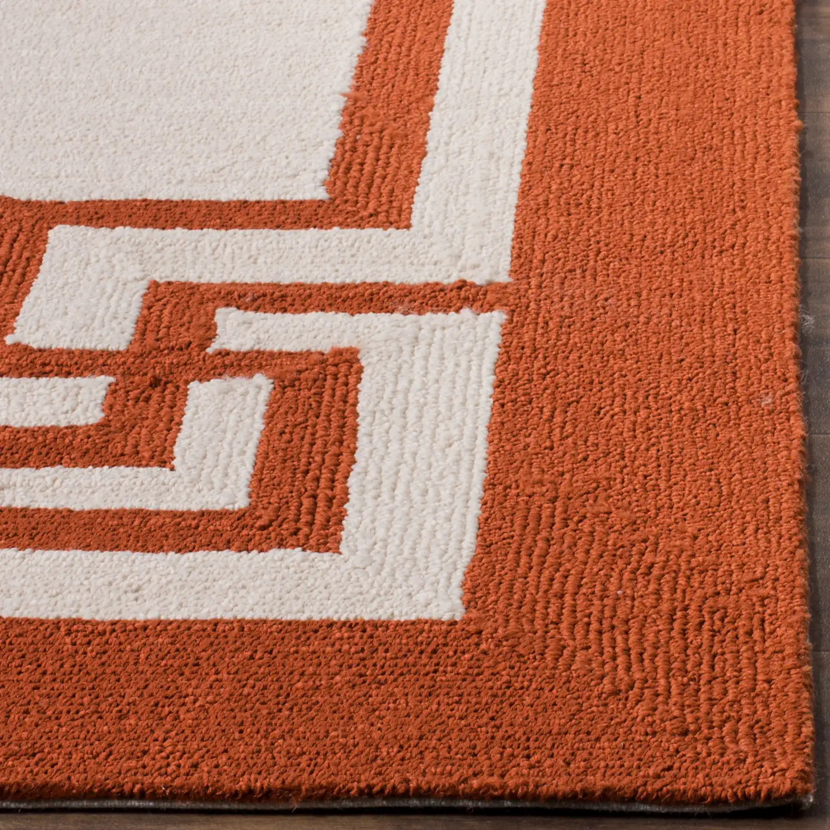 Four Seasons Greek Key Border Hand-Hooked Rug in Off-White / Sangria in a styled room