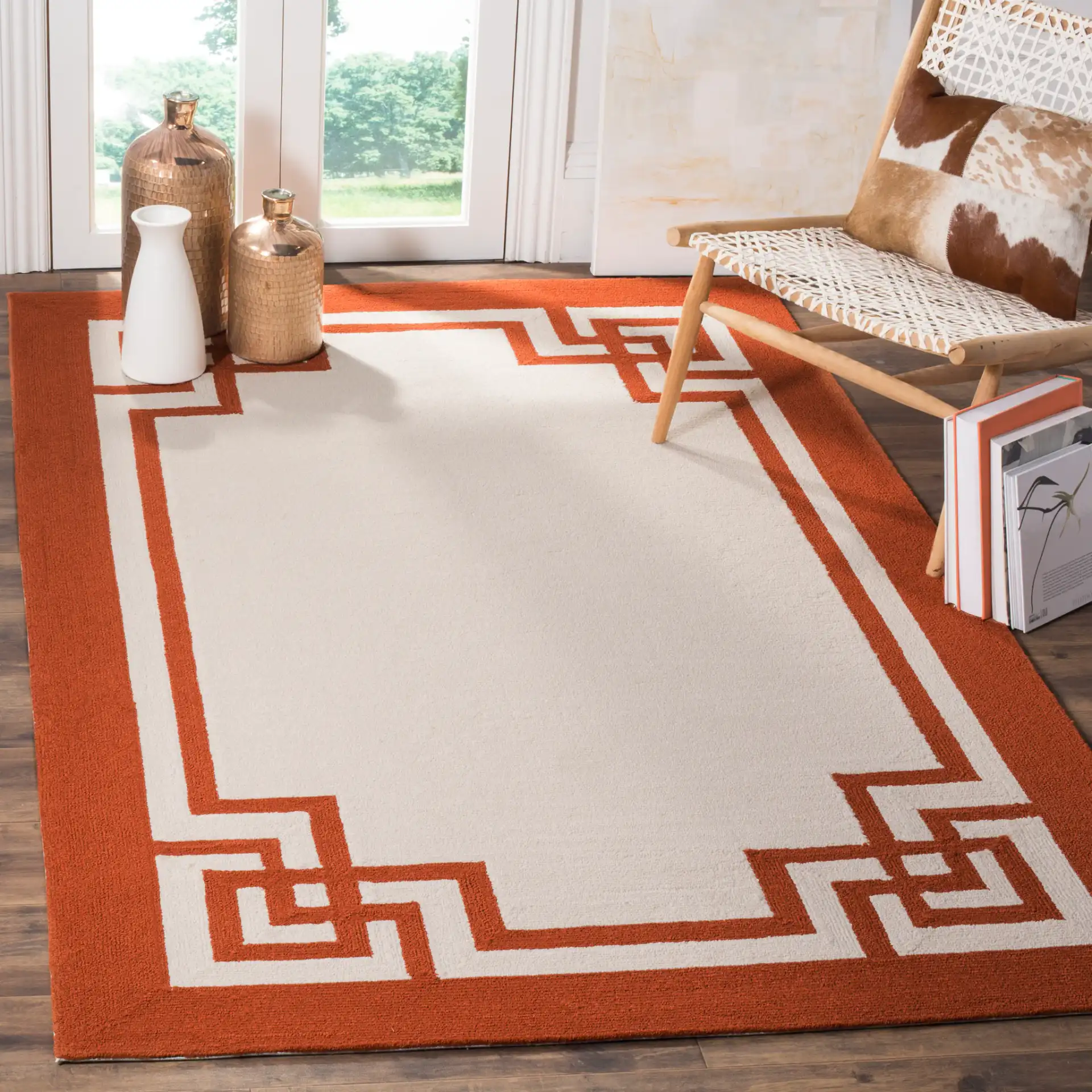 Four Seasons Greek Key Border Hand-Hooked Rug in Off-White / Sangria in a styled room