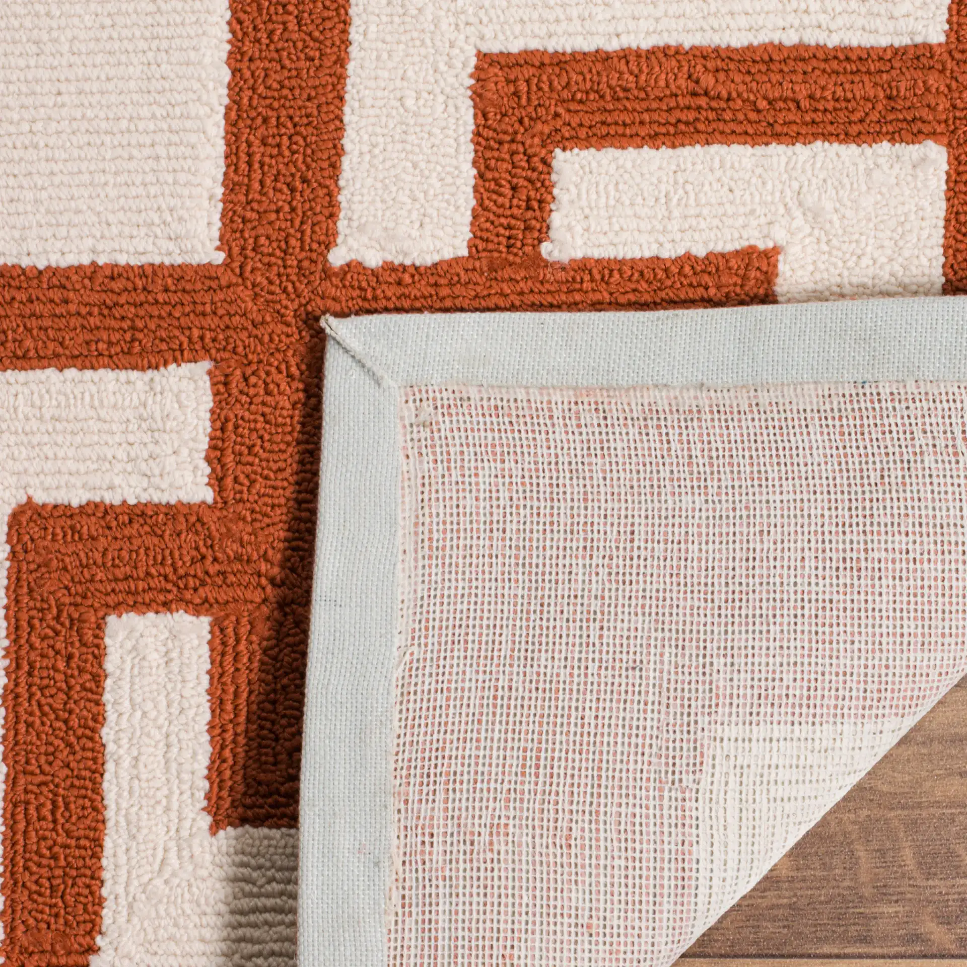 Four Seasons Greek Key Border Hand-Hooked Rug in Off-White / Sangria in a styled room