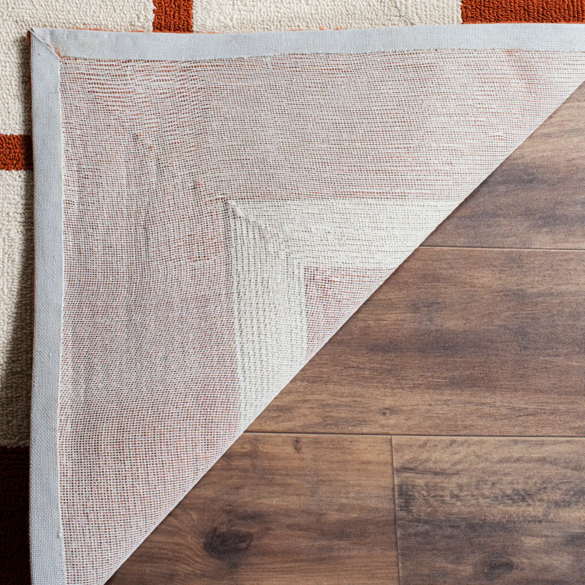 Four Seasons Greek Key Border Hand-Hooked Rug in Off-White / Sangria in a styled room
