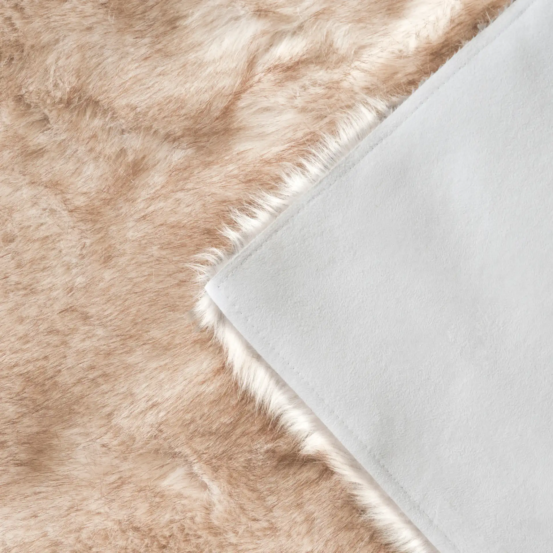 Faux Sheep Skin Solid Shag Rug in Beige / Brown in a styled room