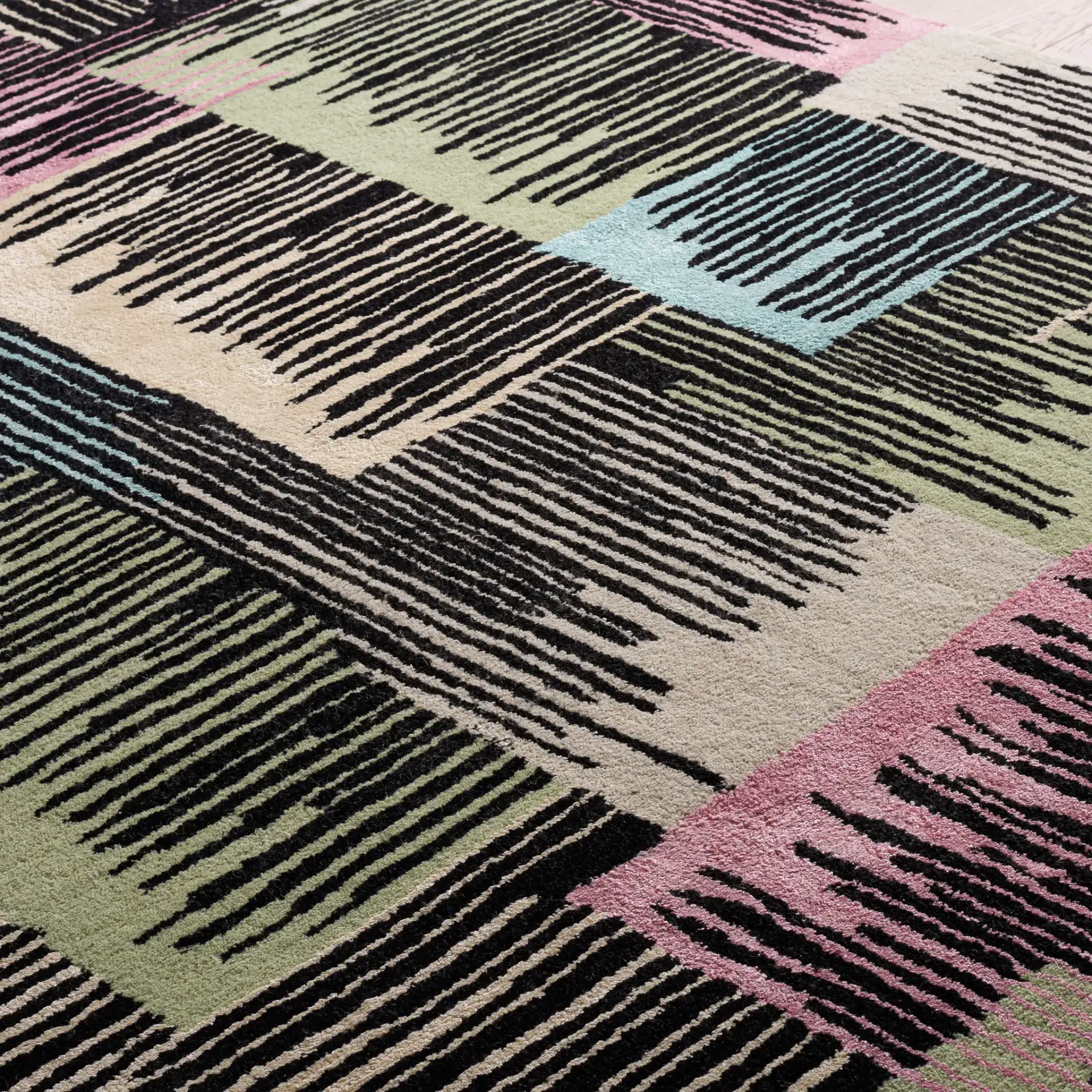 Fifth Avenue Abstract Hatch Block Hand-Tufted Rug in Black / Pink in a styled room