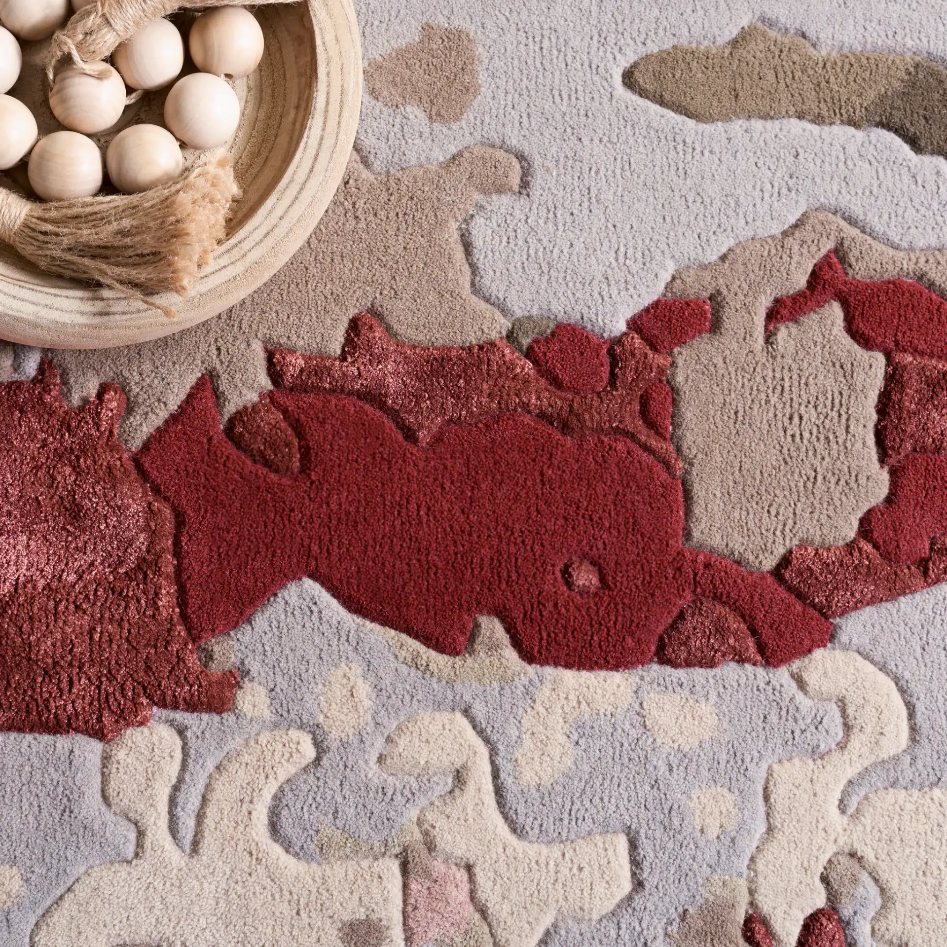 Fifth Avenue Abstract Pools Hand-Tufted Rug in Gray / Red in a styled room