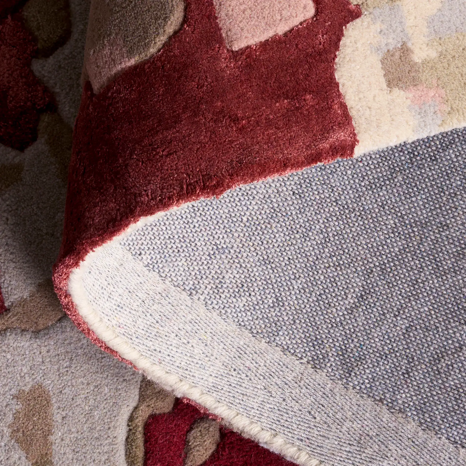 Fifth Avenue Abstract Pools Hand-Tufted Rug in Gray / Red in a styled room