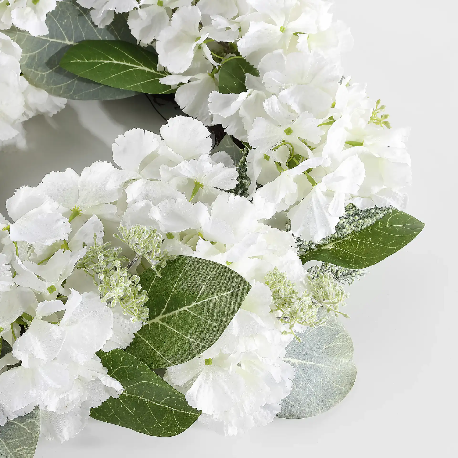 Faux 22" Hydrangea & Magnolia Wreath in White / Green in a styled room