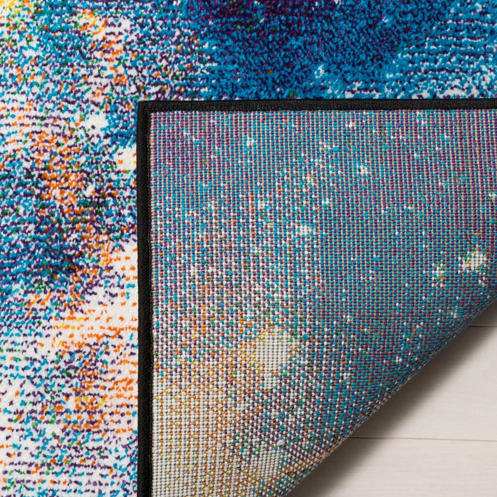 Galaxy Nebula Rug in Purple / Multicolor in a styled room