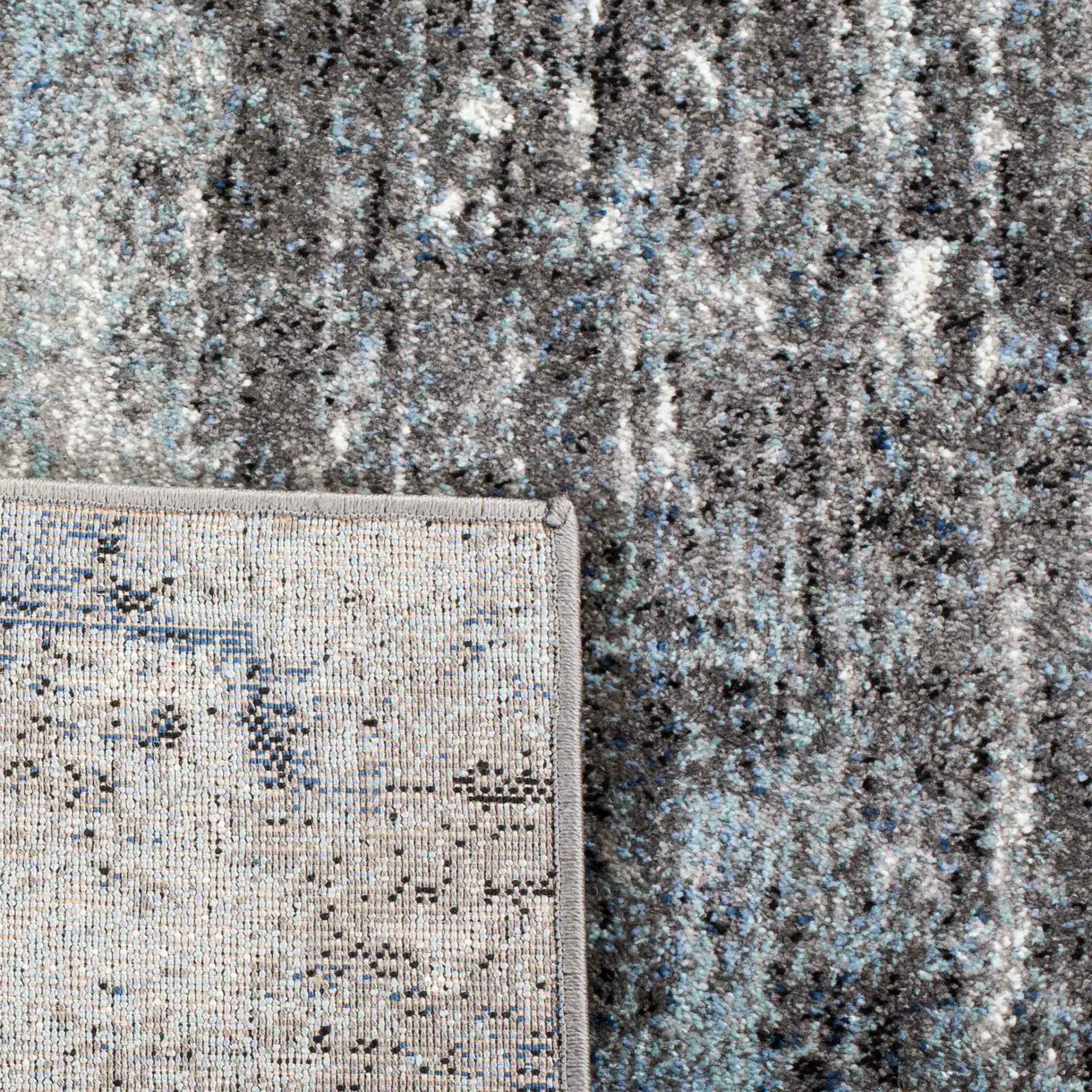 Galaxy Striated Abstract Rug in Charcoal / Blue in a styled room