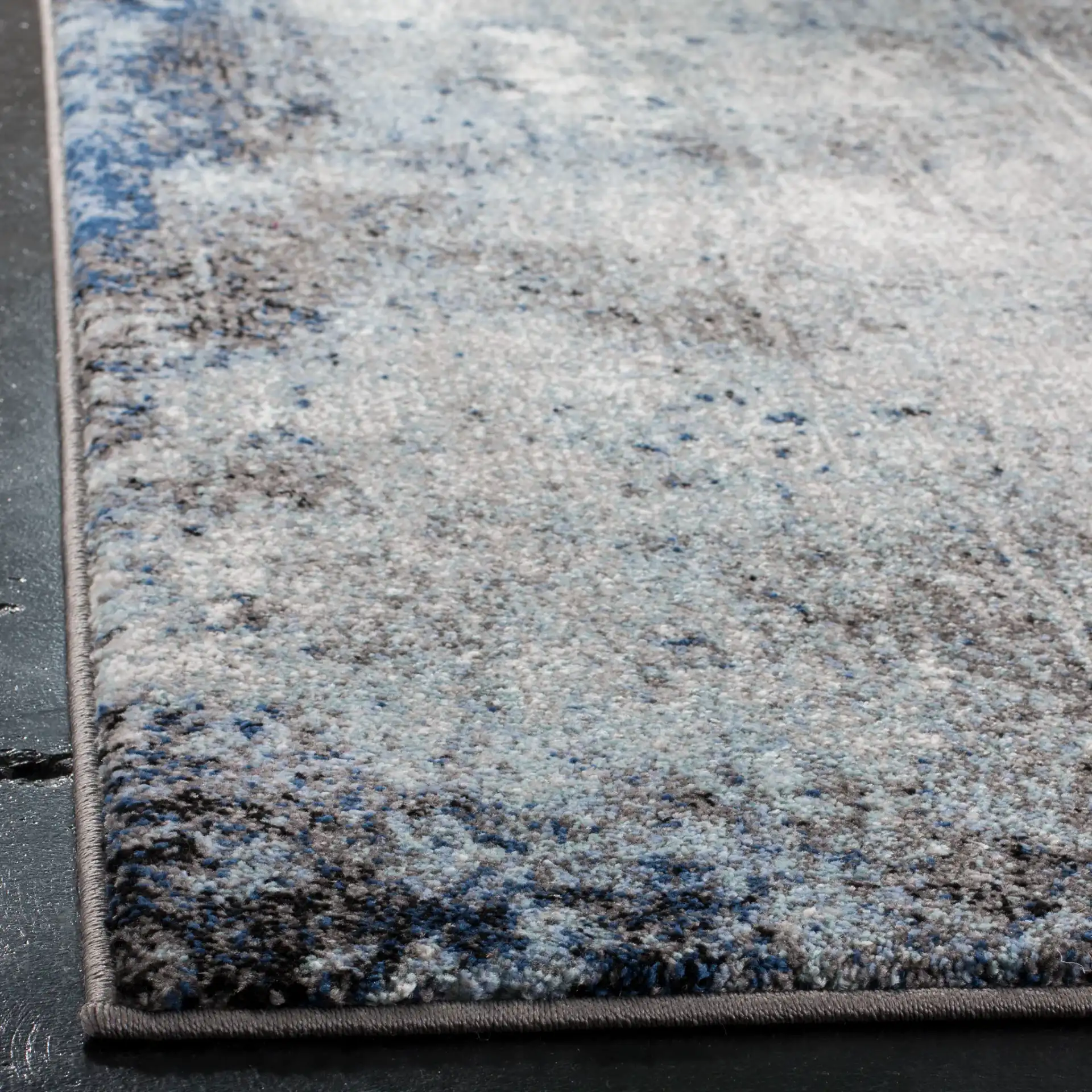 Galaxy Striated Abstract Rug in Charcoal / Blue in a styled room