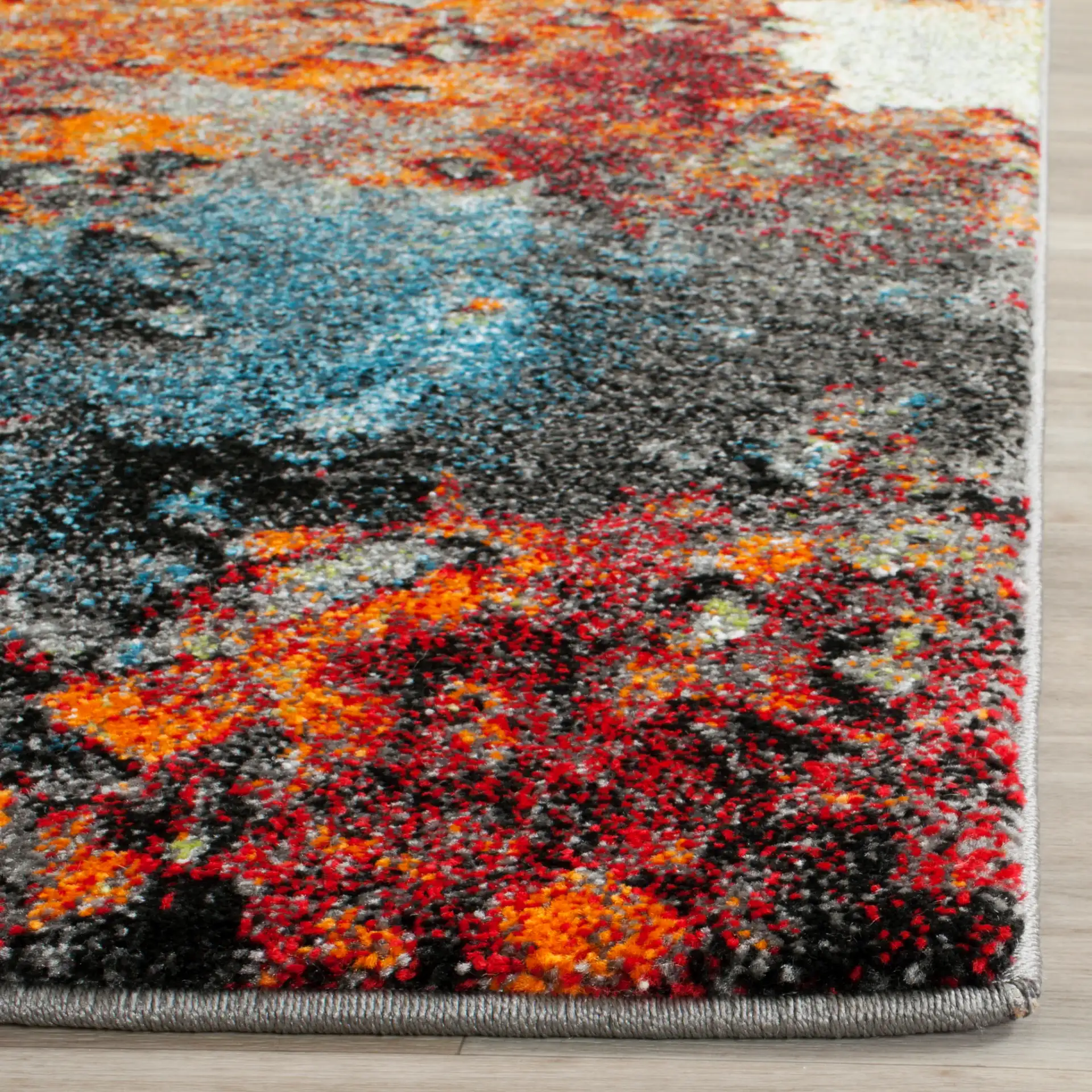 Glacier Abstract Rug in Blue / Multicolor in a styled room