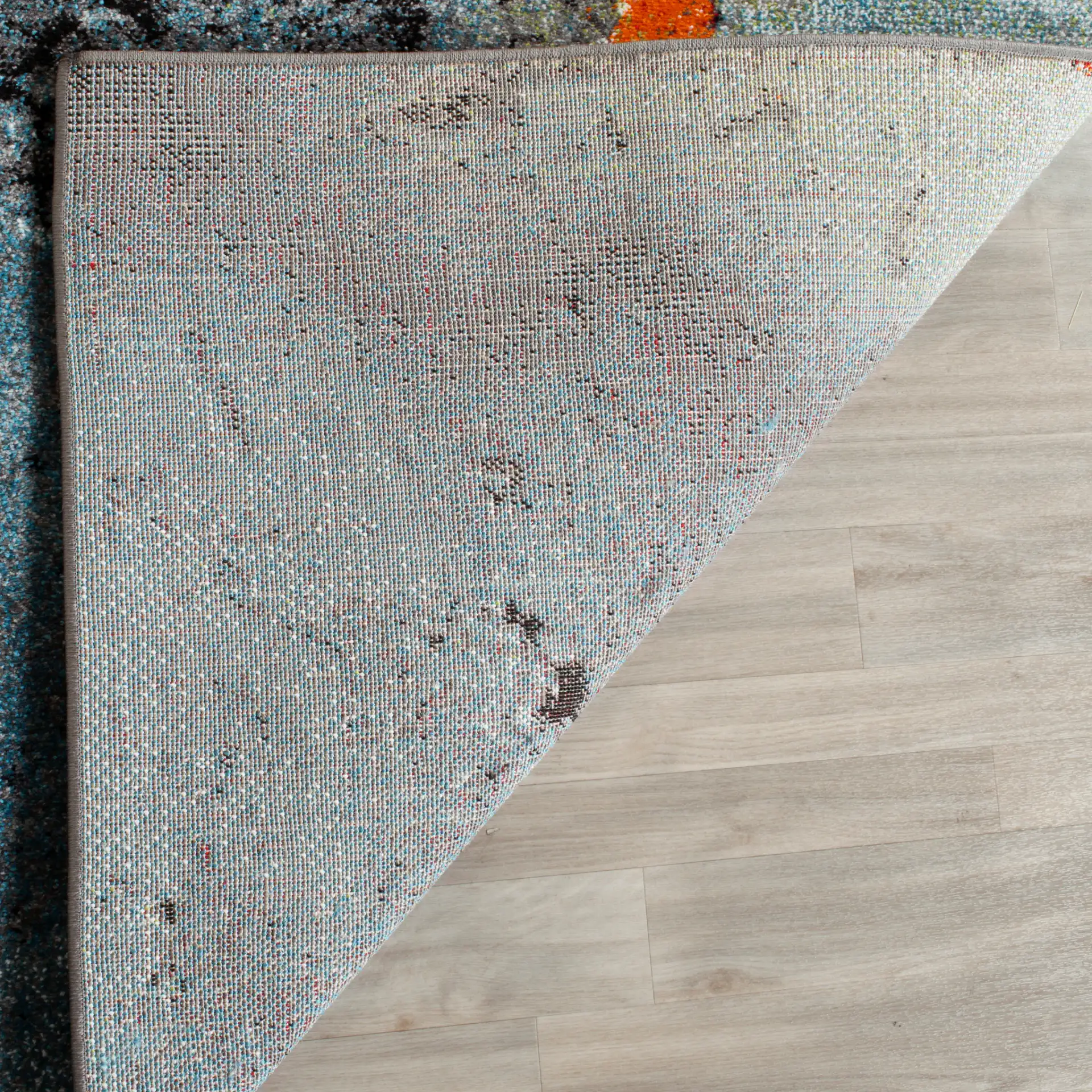Glacier Abstract Rug in Blue / Multicolor in a styled room