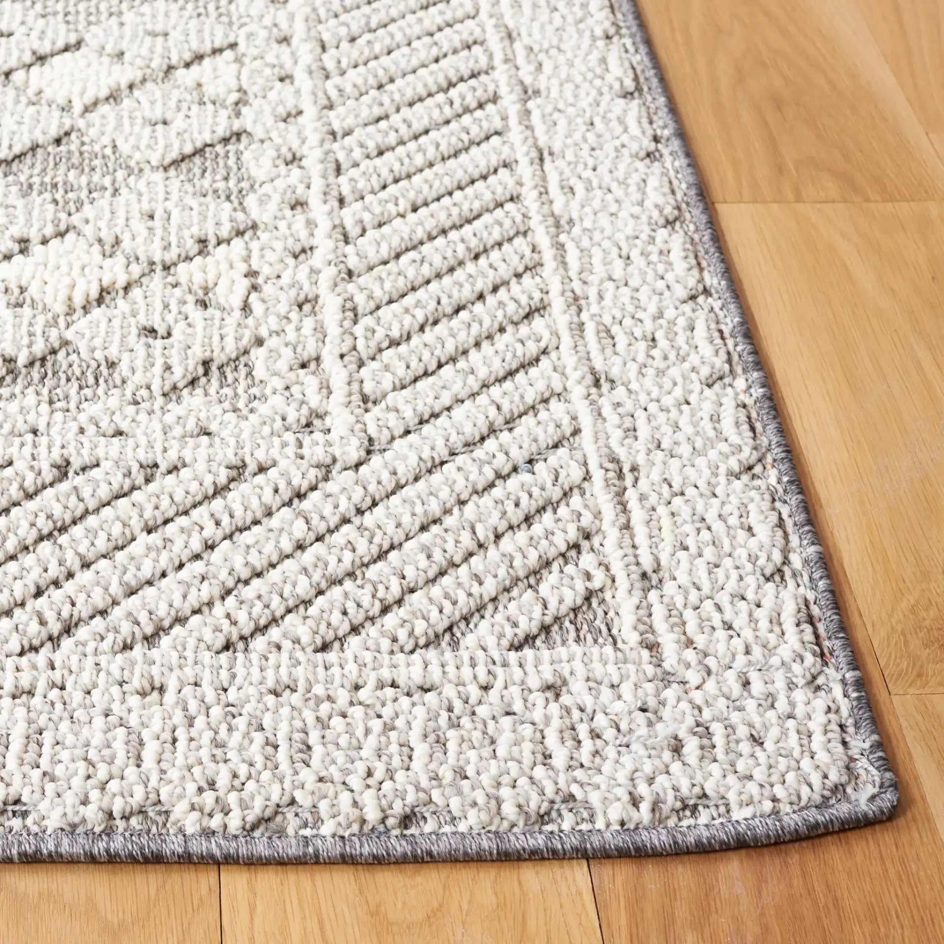Global Bordered Diamond Rug in Light Gray / Dark Gray in a styled room