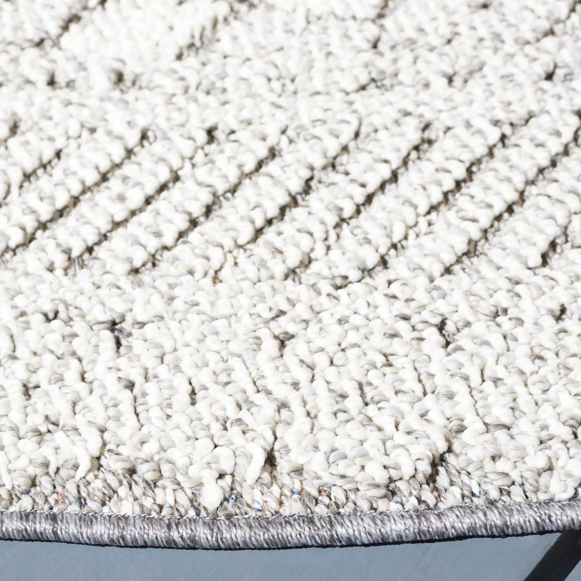 Global Bordered Diamond Rug in Light Gray / Dark Gray in a styled room