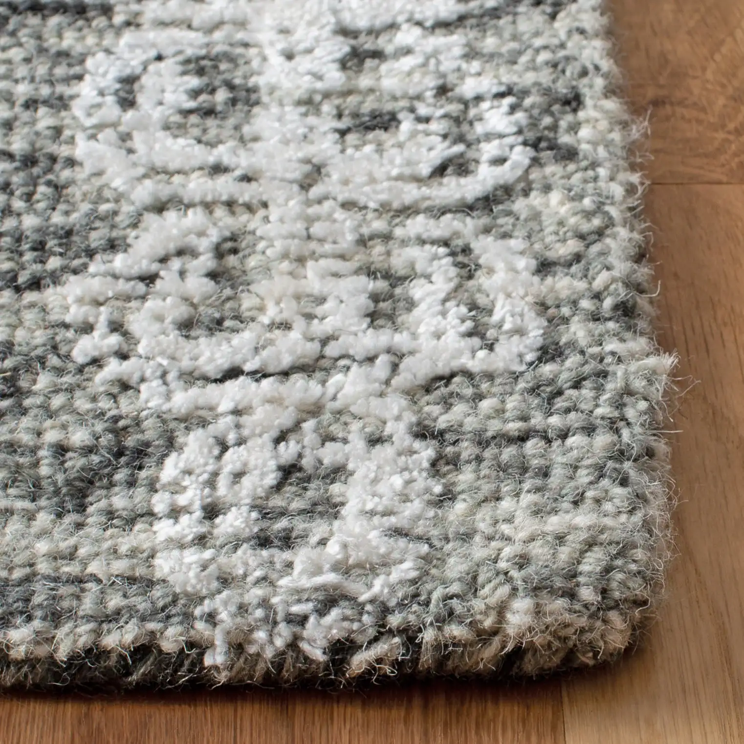Glamour Distressed Damask Hand-Tufted Rug in Charcoal in a styled room
