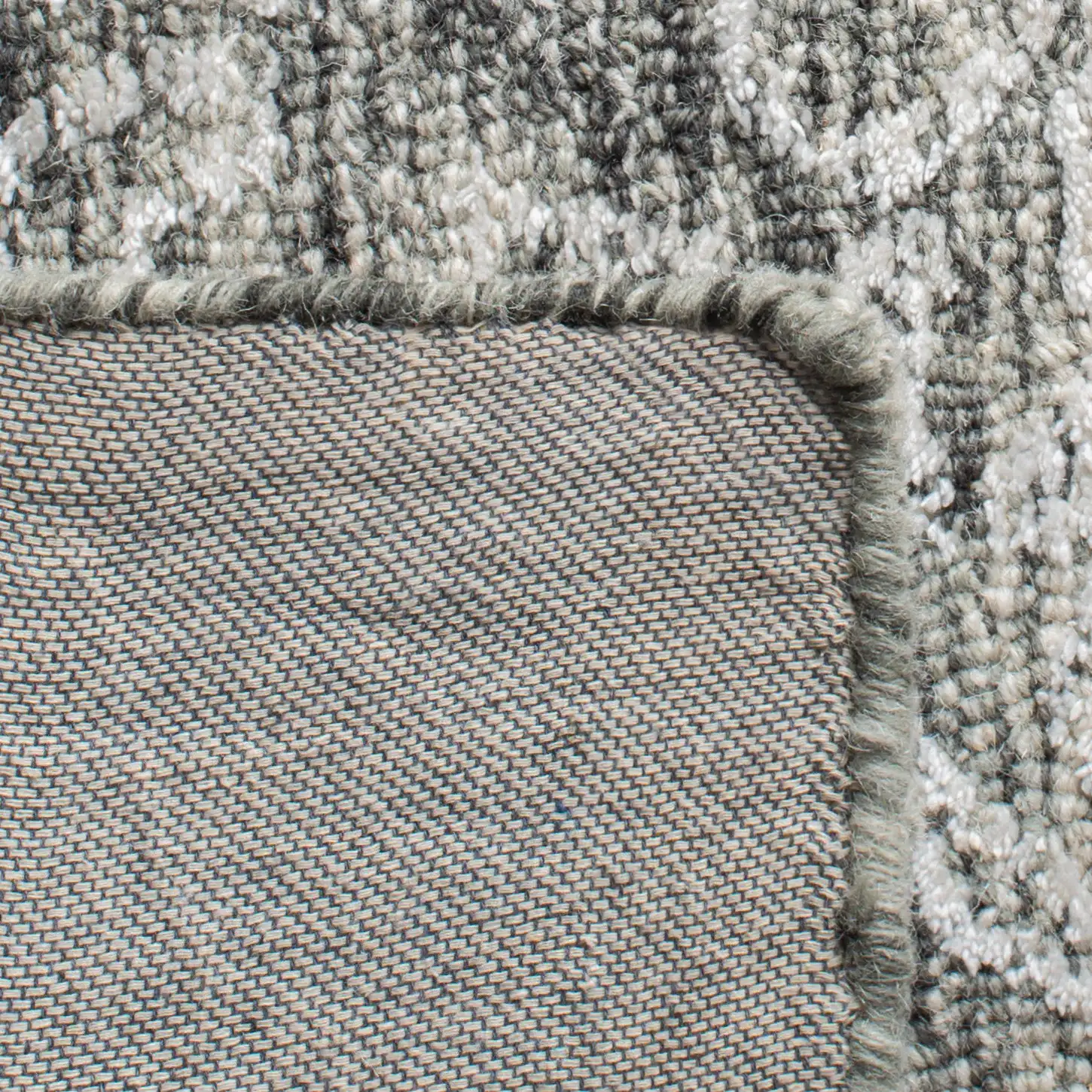 Glamour Distressed Damask Hand-Tufted Rug in Charcoal in a styled room