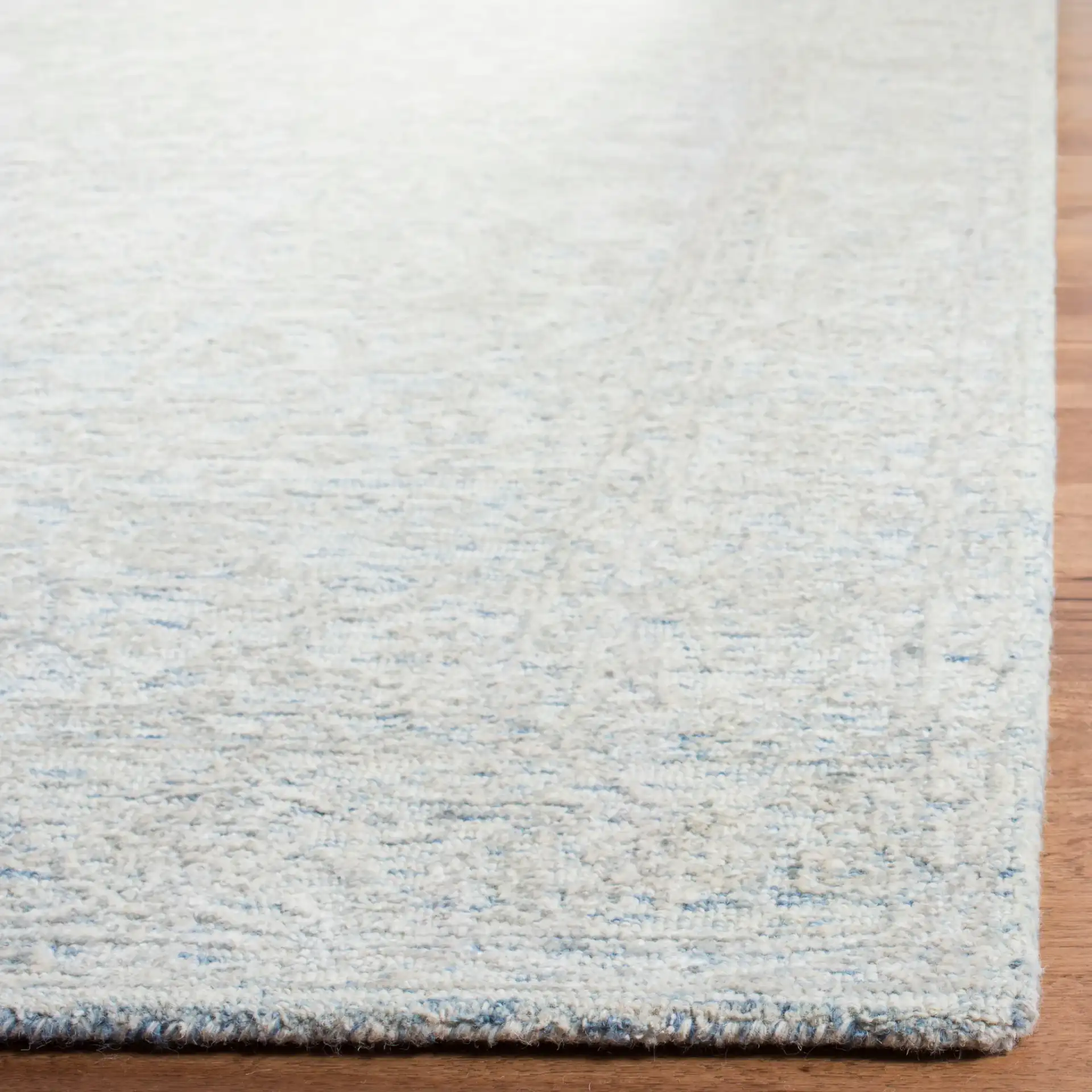 Glamour Erased Medallion Hand-Tufted Rug in Blue / Ivory in a styled room