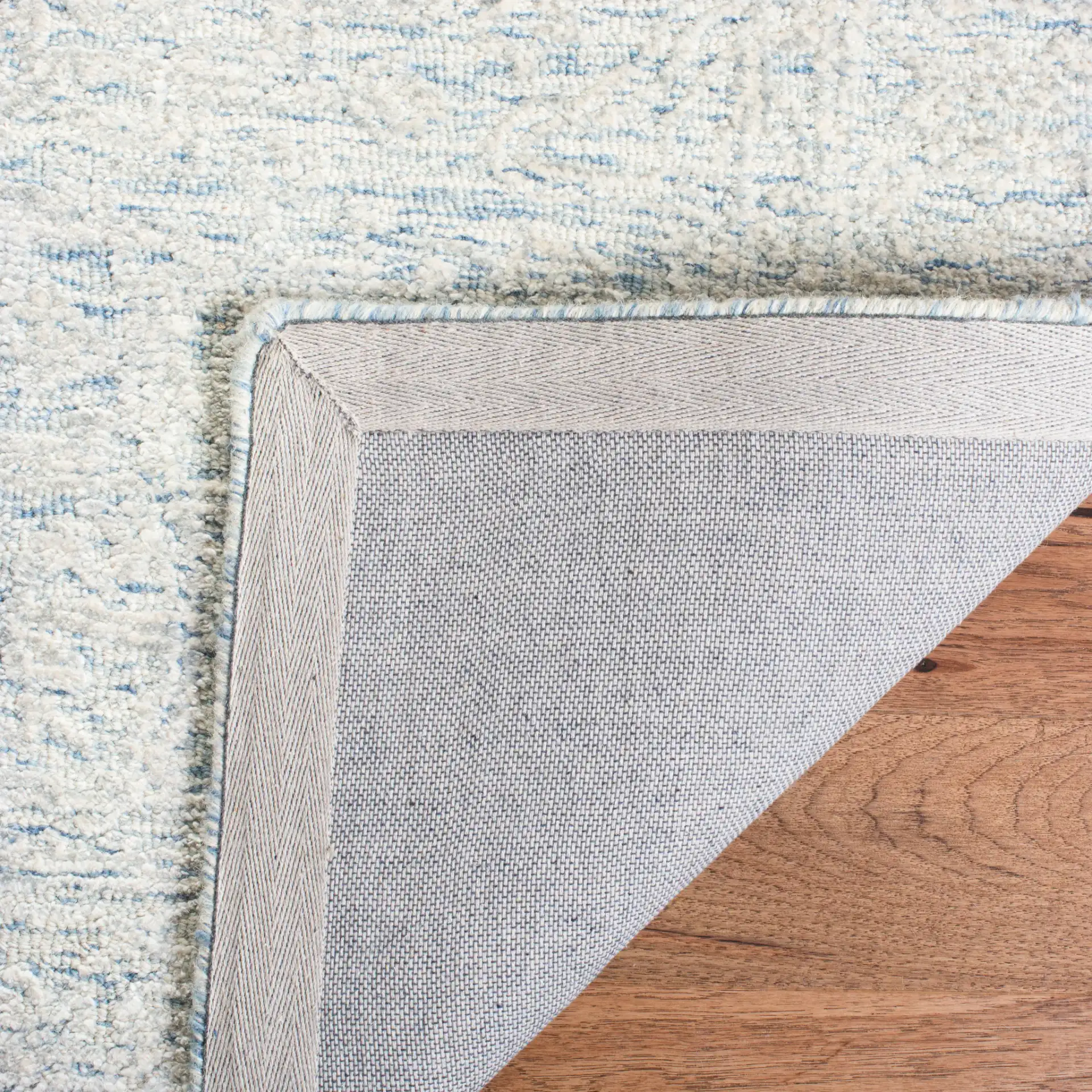Glamour Erased Medallion Hand-Tufted Rug in Blue / Ivory in a styled room