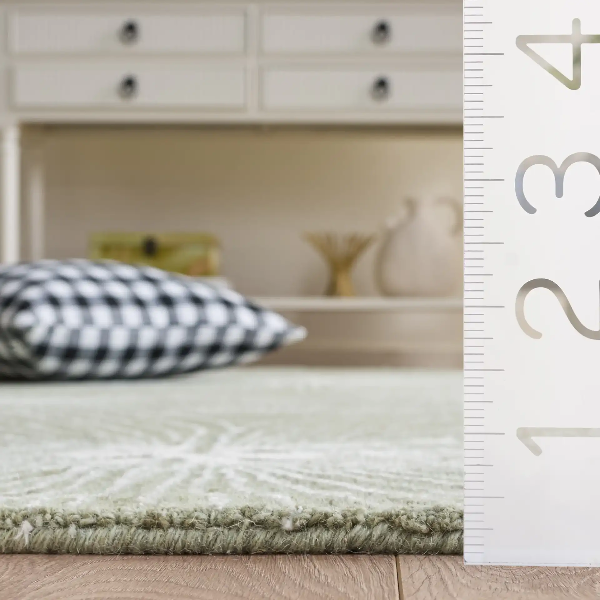 Glamour Floral Burst Hand-Tufted Rug in Sage / Ivory in a styled room