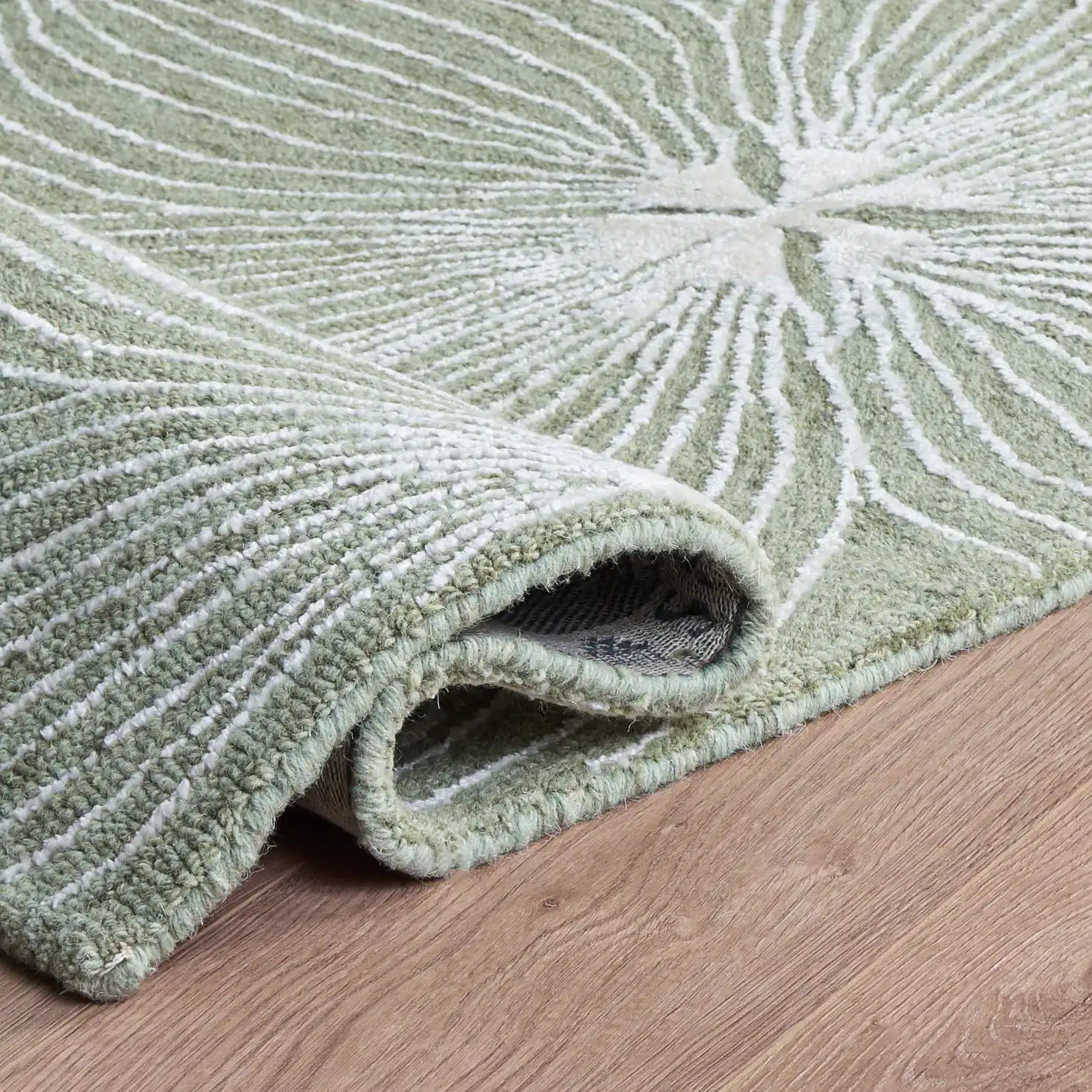 Glamour Floral Burst Hand-Tufted Rug in Sage / Ivory in a styled room