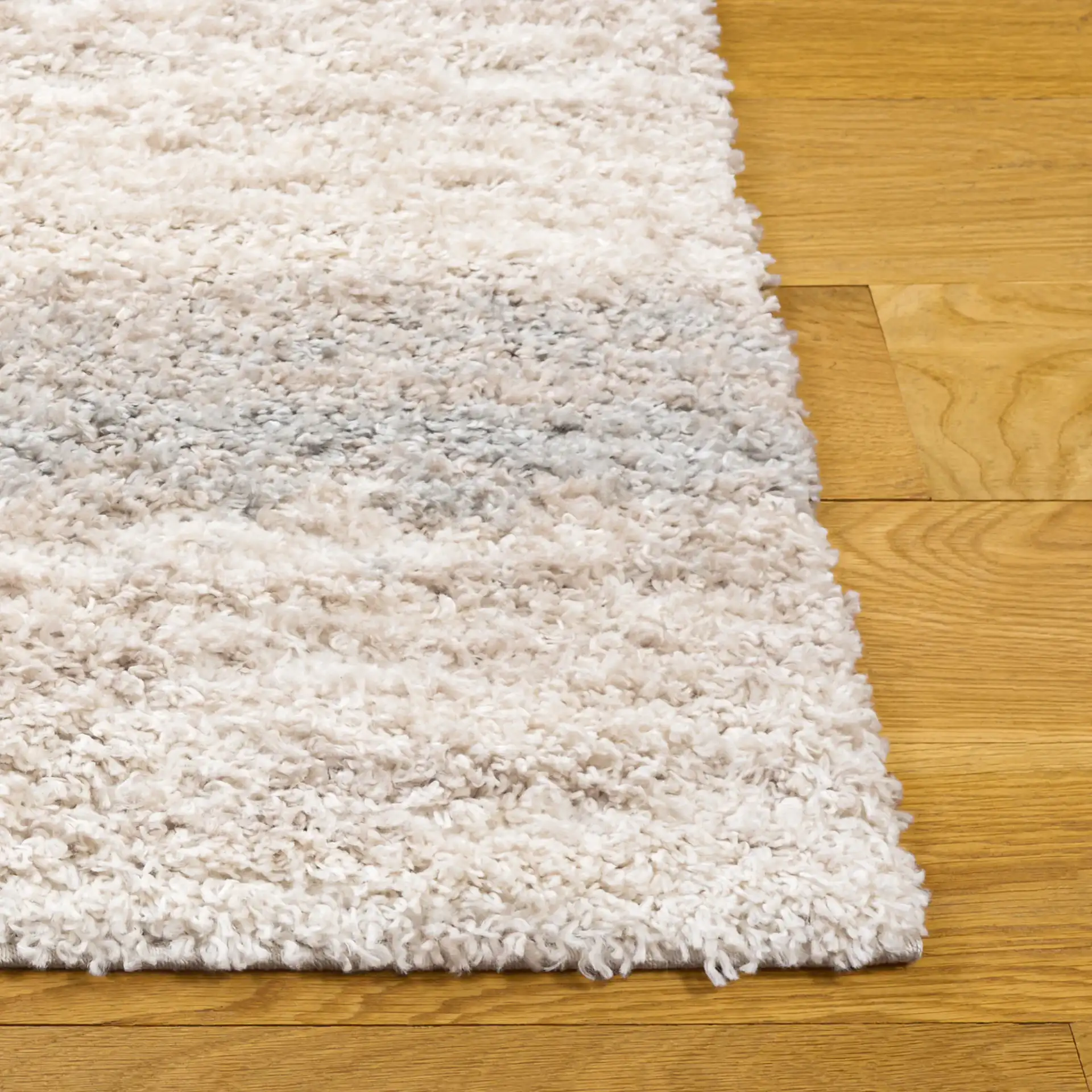 Gemma Tulum Banded Stripe Shag Rug in Ivory / Beige Gray in a styled room