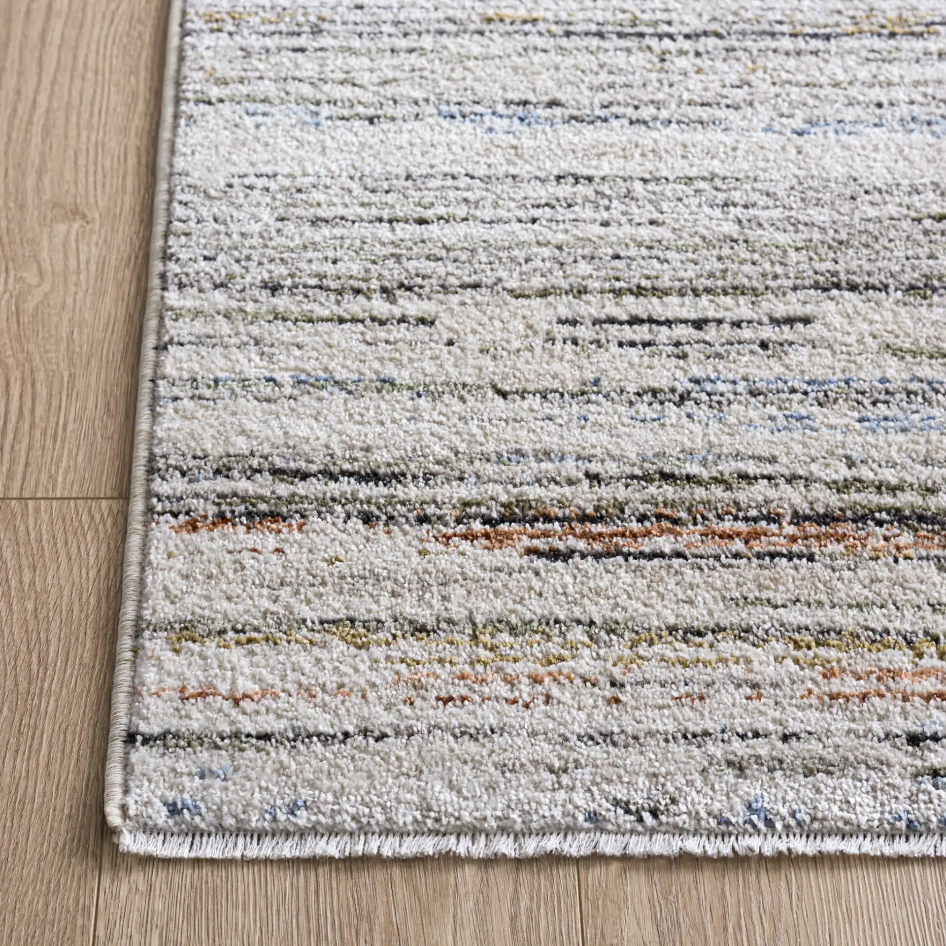 Grove Linear Stripe Rug in Ivory / Blue Rust in a styled room