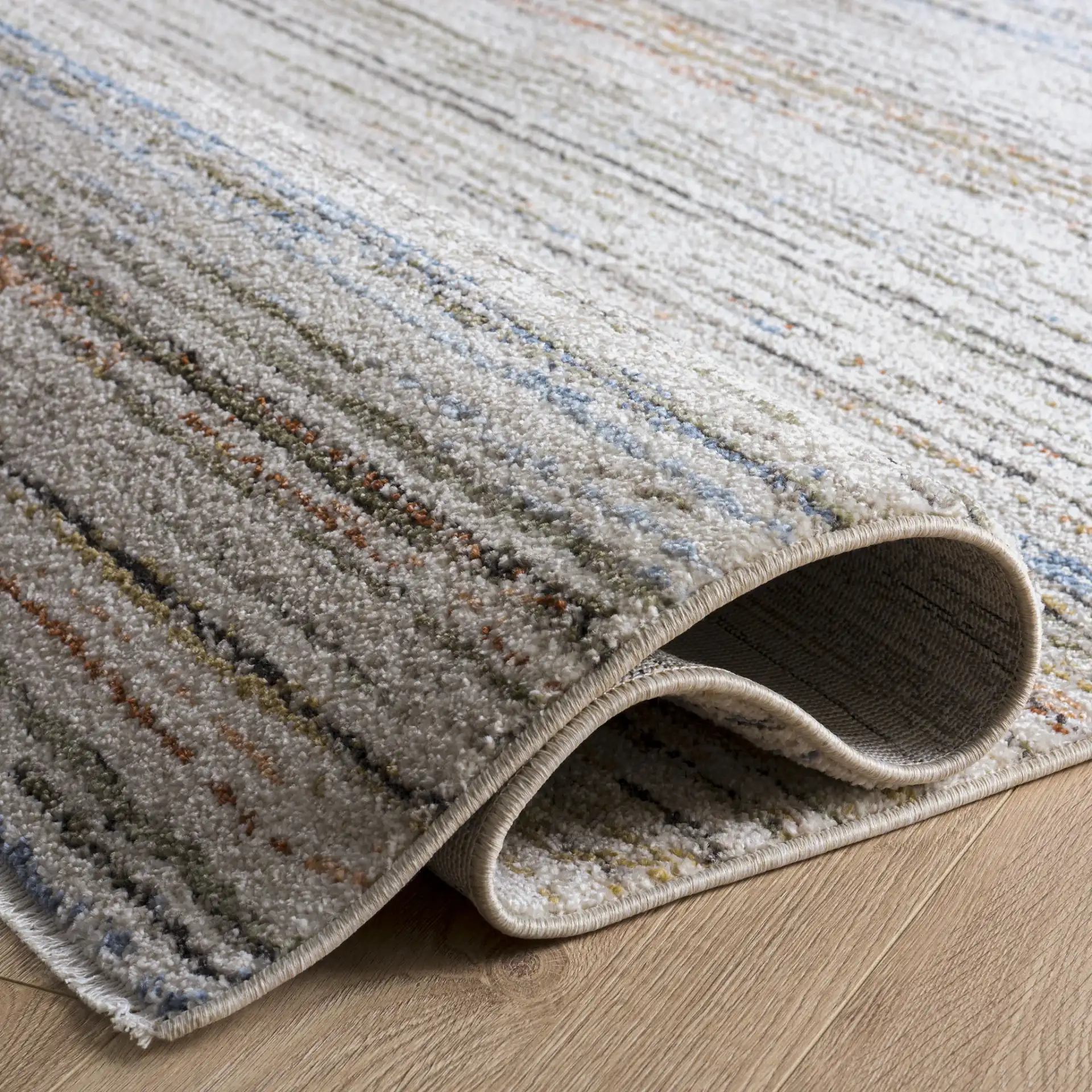 Grove Linear Stripe Rug in Ivory / Blue Rust in a styled room