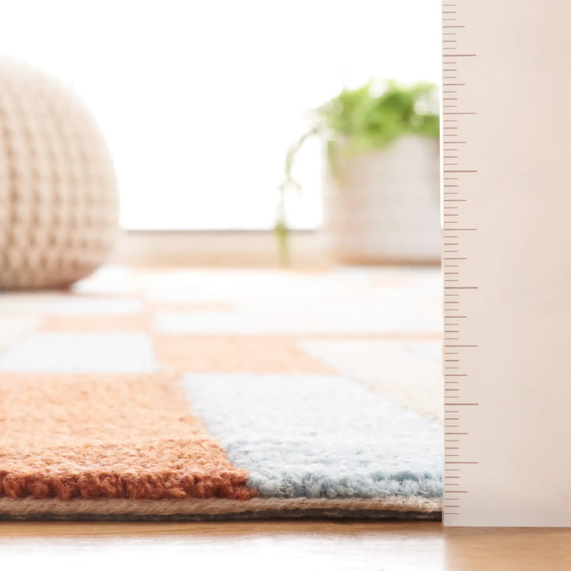 Genre Interlocking Rectangles Hand-Tufted Wool Rug in Light Blue / Rust in a styled room